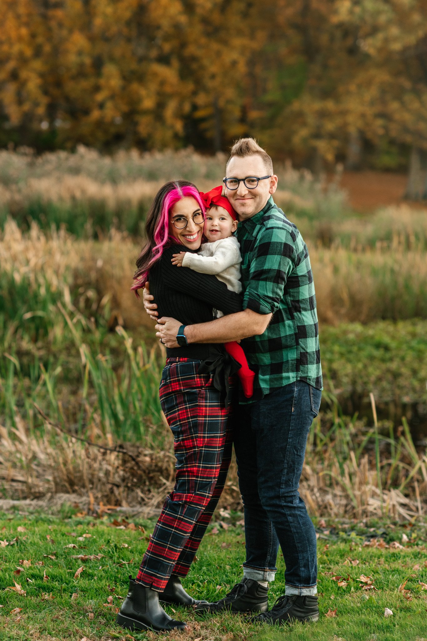  A professional family photographer captures a family hugging while wearing plaids by Nicole Hawkins Photography. family hug pose #NicoleHawkinsPhotography #NicoleHawkinsFamily #fallfamilyphotos #fallphotos #familyphotographerNJ #NJfallfamilypics 