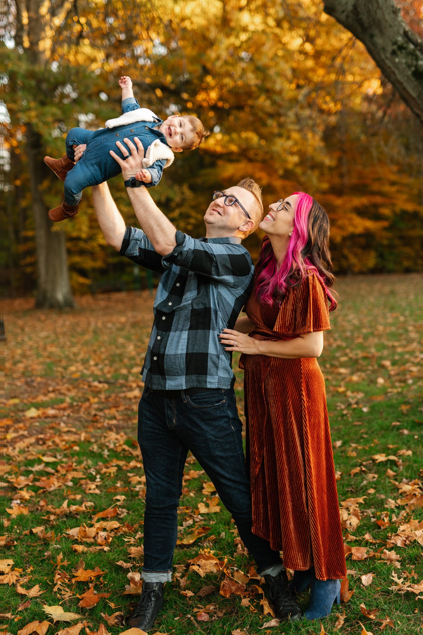  baby giggles as her daddy throws her in the air by Nicole Hawkins Photography in New Jersey. father throwing baby #NicoleHawkinsPhotography #NicoleHawkinsFamily #fallfamilyphotos #fallphotos #familyphotographerNJ #NJfallfamilypics 