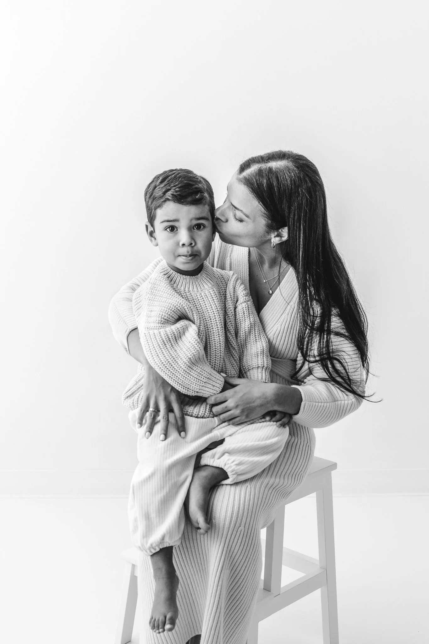  A mother kisses her little boy's cheek during a modern mommy and me session with Nicole Hawkins Photography. Mommy and me #NicoleHawkinsPhotograaphy #NicoleHawkinsChildren #StudioBabies&amp;Children #NJphotographers #modernportraits #mom&amp;meportr