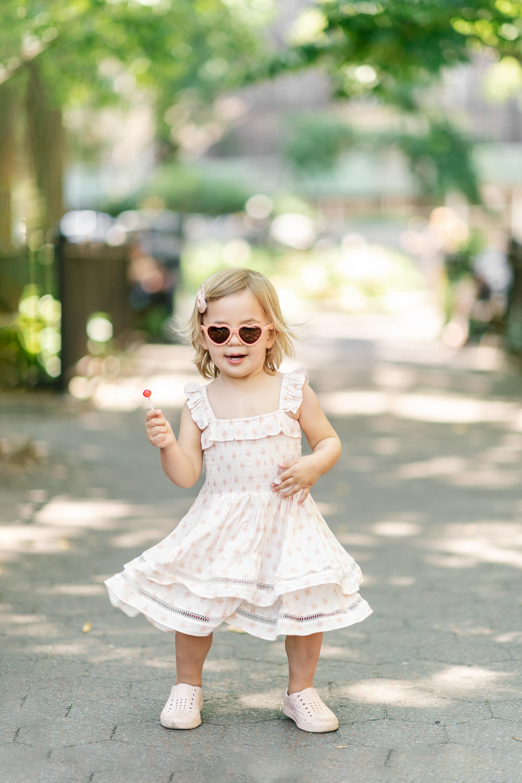  Outdoor portrait captured of a little girl wearing her sunglasses and dancing by Nicole Hawkins Photography. sassy toddler #NicoleHawkinsPhotograaphy #NicoleHawkinsChildren #NewYorkPortraits #KidsinNewYork #ChildrensPortraits #lifestyleportraits 