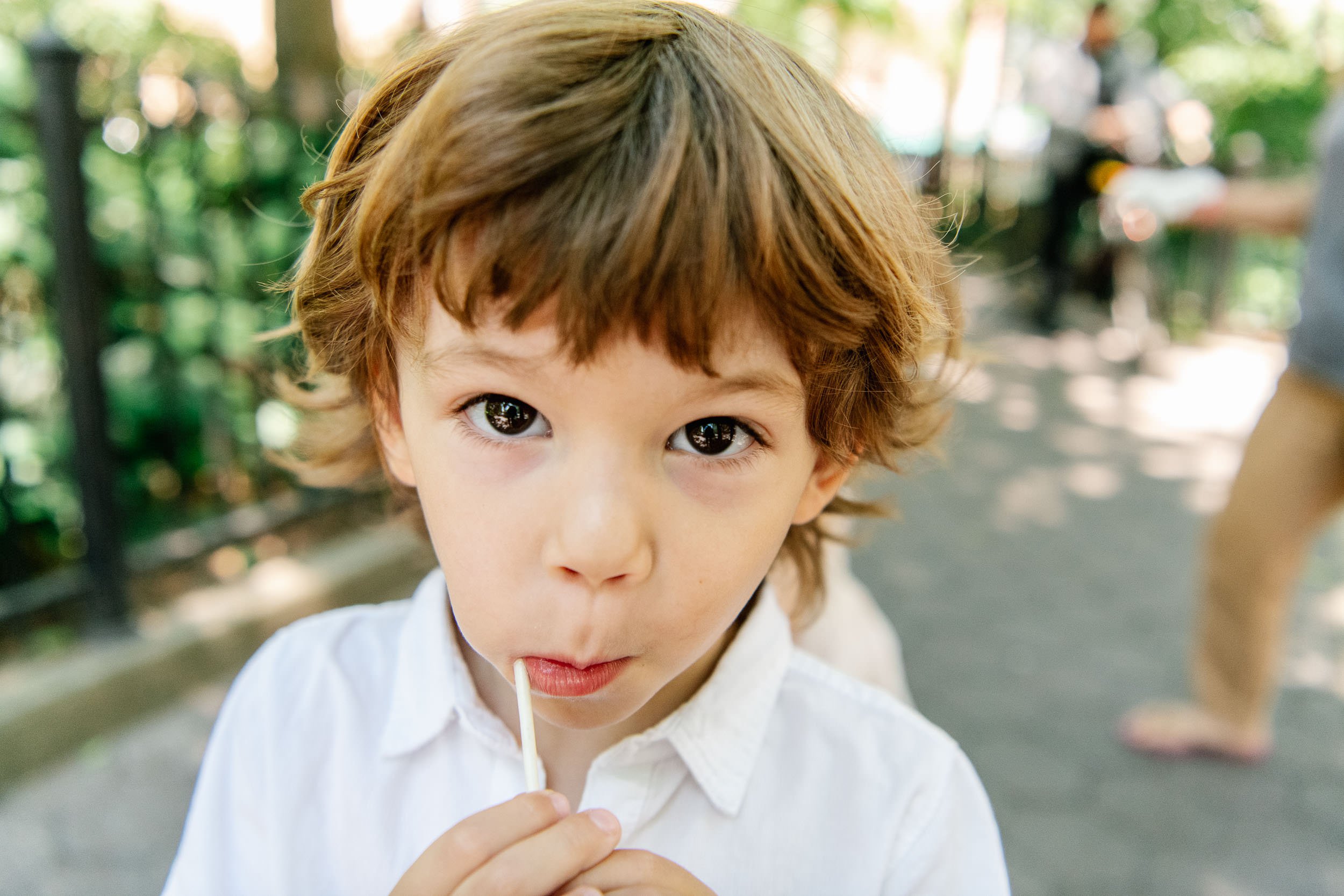  Nicole Hawkins Photography captures a face portrait of a little boy eating a sucker in NYC. NYC family pictures #NicoleHawkinsPhotograaphy #NicoleHawkinsChildren #NewYorkPortraits #KidsinNewYork #ChildrensPortraits #lifestyleportraits 