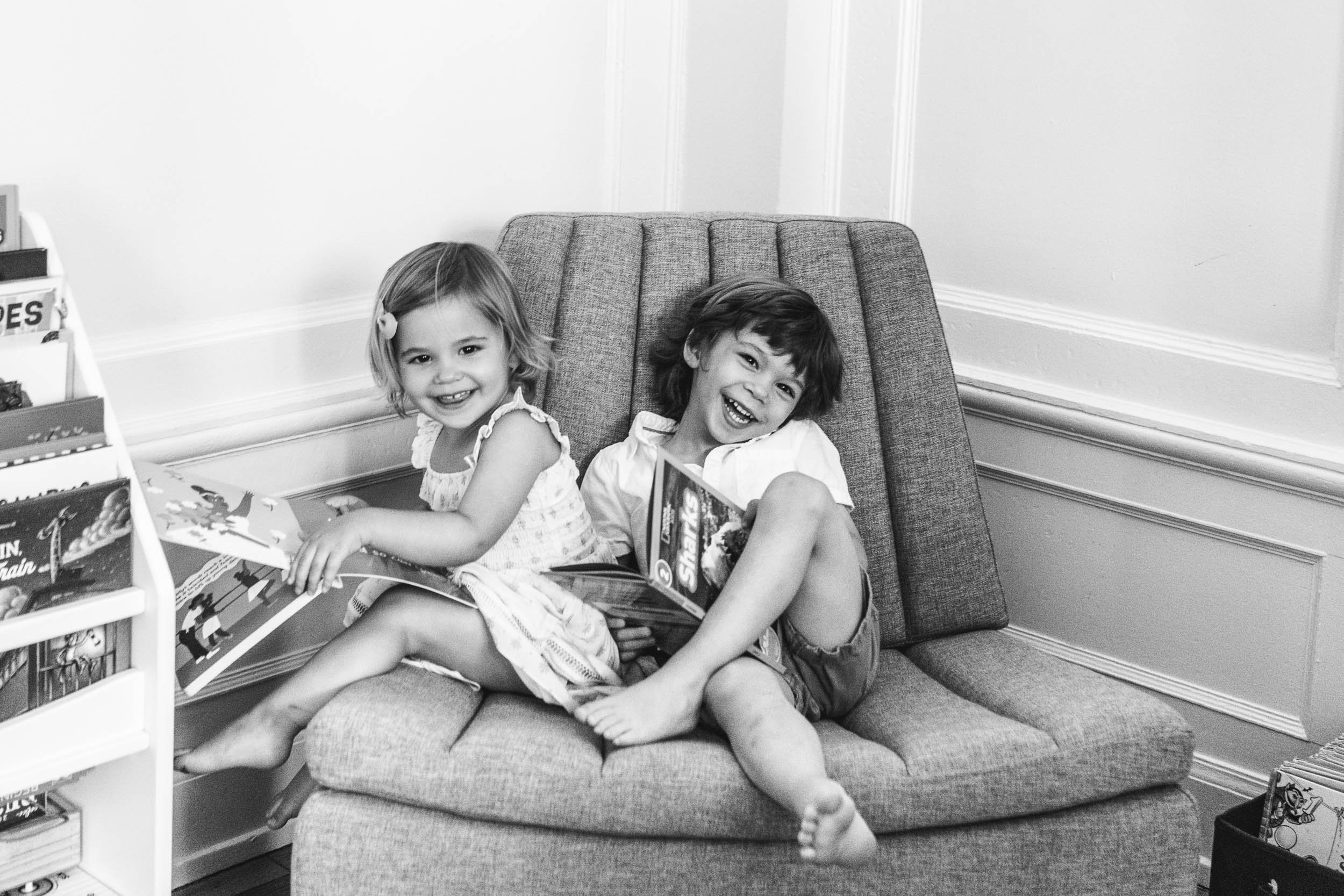 Timeless black and white portrait of a boy and girl sitting on a lounger reading by Nicole Hawkins Photography. modern pic #NicoleHawkinsPhotograaphy #NicoleHawkinsChildren #NewYorkPortraits #KidsinNewYork #ChildrensPortraits #lifestyleportraits 