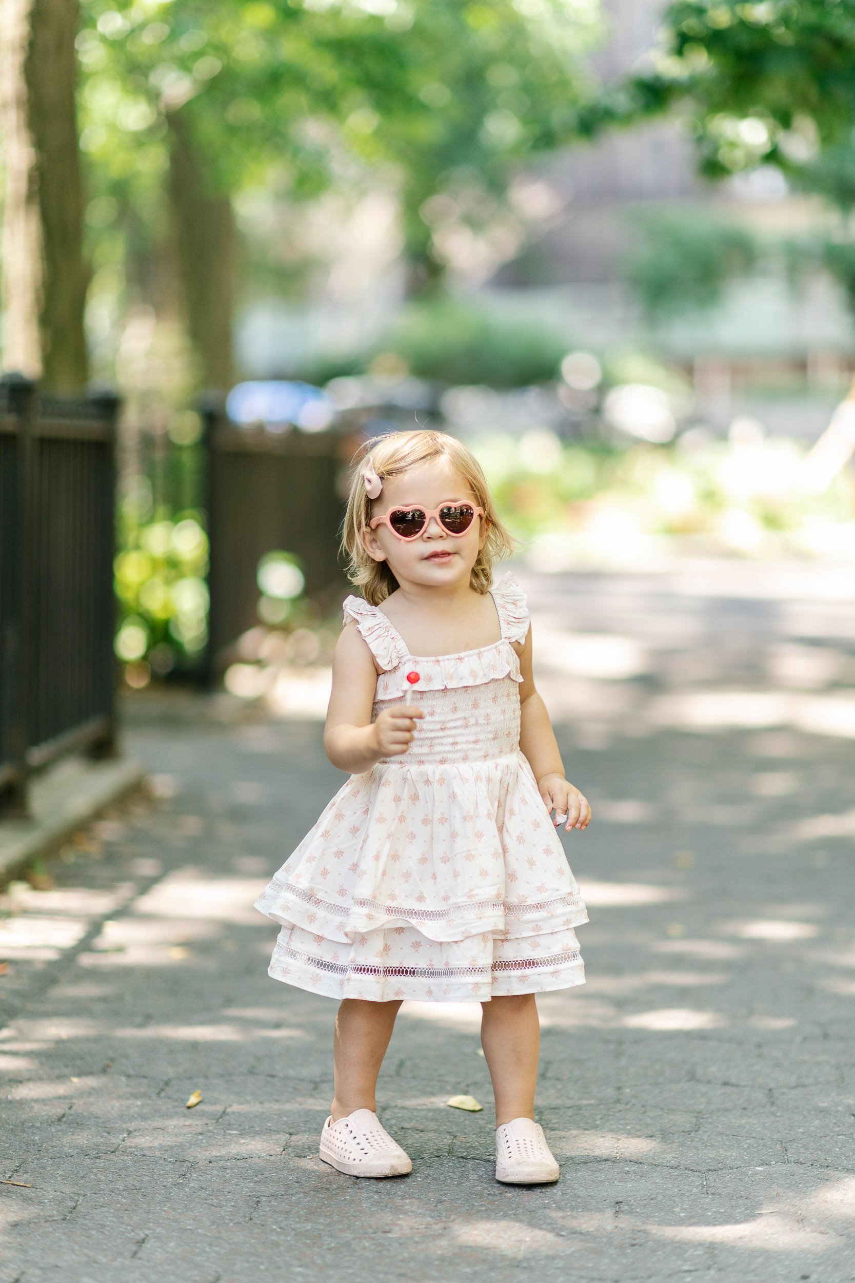  Nicole Hawkins Photography captures a clean and bright portrait of a little girl with a sucker in NYC. candid authentic #NicoleHawkinsPhotograaphy #NicoleHawkinsChildren #NewYorkPortraits #KidsinNewYork #ChildrensPortraits #lifestyleportraits 