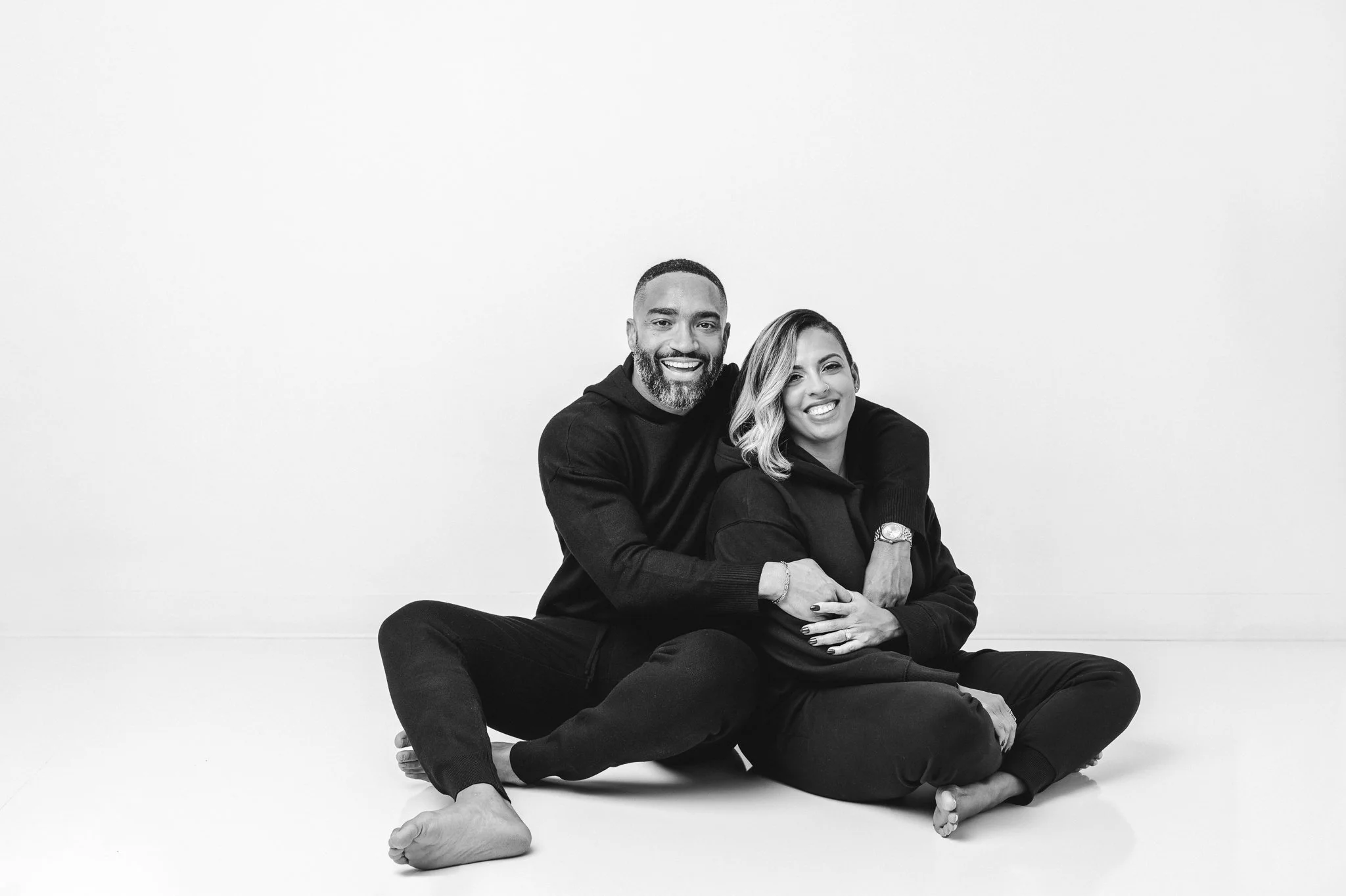  The husband and wife portrait took at a white studio with the couple wearing black by Nicole Hawkins Photography. couples #NicoleHawkinsPhotograaphy #NicoleHawkinsFamilies #Modernfamilypictures #studioportraits #matchingfamilyoutfits #NJphotographer