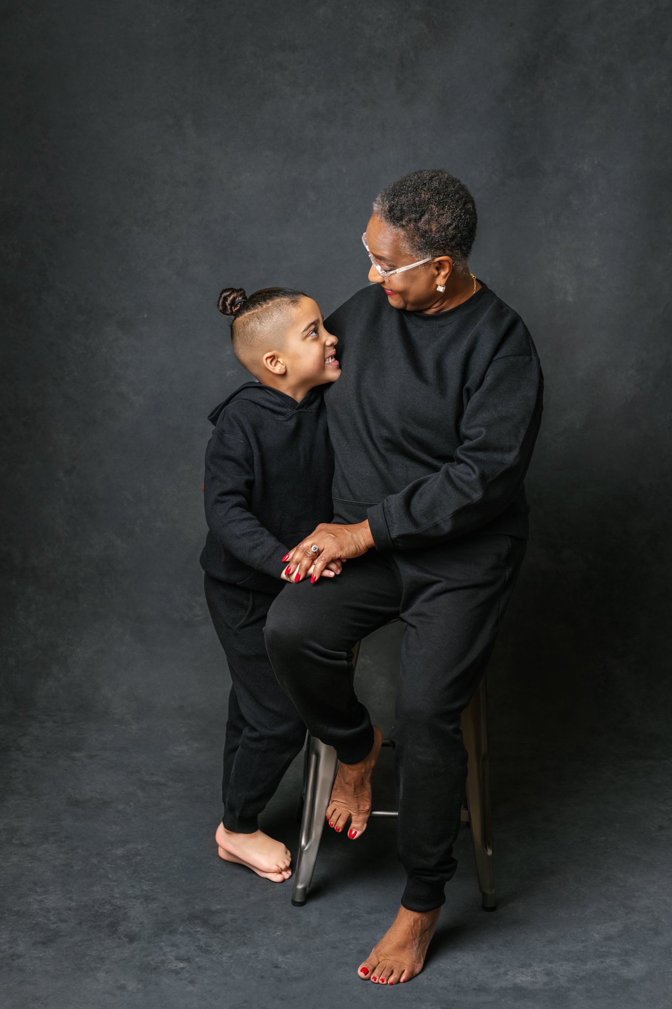  Nicole Hawkins's PHotography captures a grandmother hugging her grandson during modern studio portraits. grandma #NicoleHawkinsPhotograaphy #NicoleHawkinsFamilies #Modernfamilypictures #studioportraits #matchingfamilyoutfits #NJphotographer 