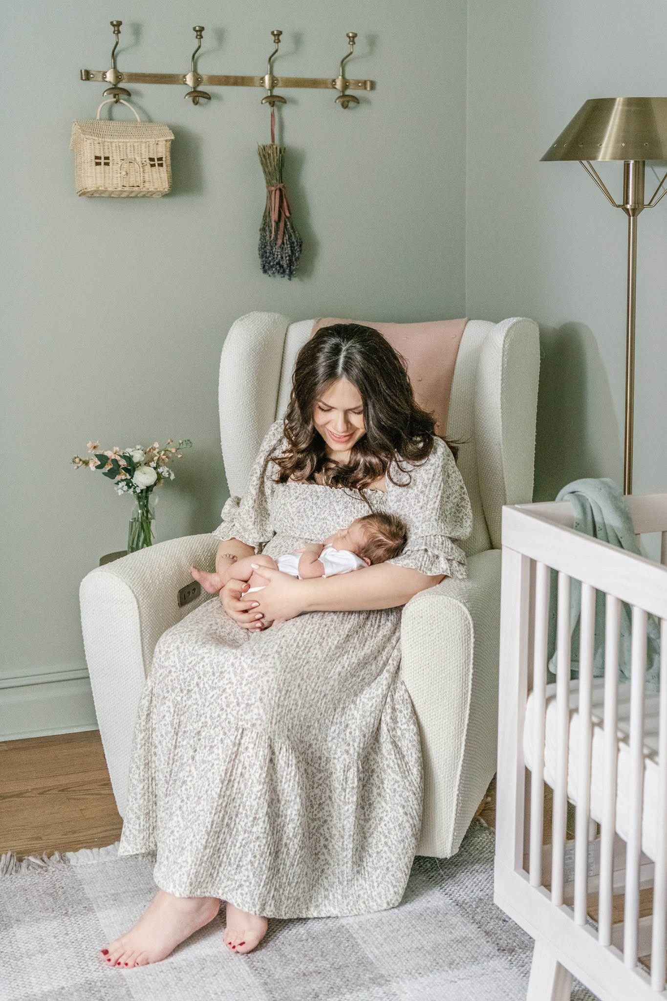  In-home newborn portrait of a mother rocking her newborn in the nursery by Nicole Hawkins Photography. mother rocking baby in chair nursery in home #NicoleHawkinsPhotography #NicoleHawkinsNewborns #MontclairNewbornPhotographer #InHomeNewborns #NJNew