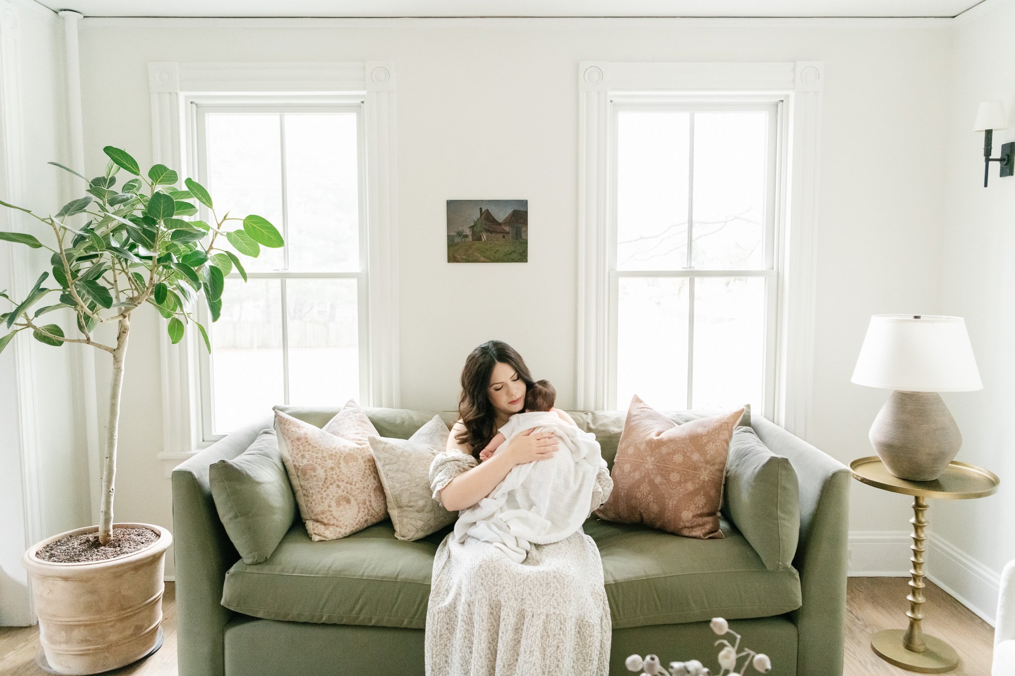  Nicole Hawkins Photography captures a portrait of a mother taking care of her baby in her own home. mother burping baby on couch #NicoleHawkinsPhotography #NicoleHawkinsNewborns #MontclairNewbornPhotographer #InHomeNewborns #NJNewborns #Babygirl #Ne