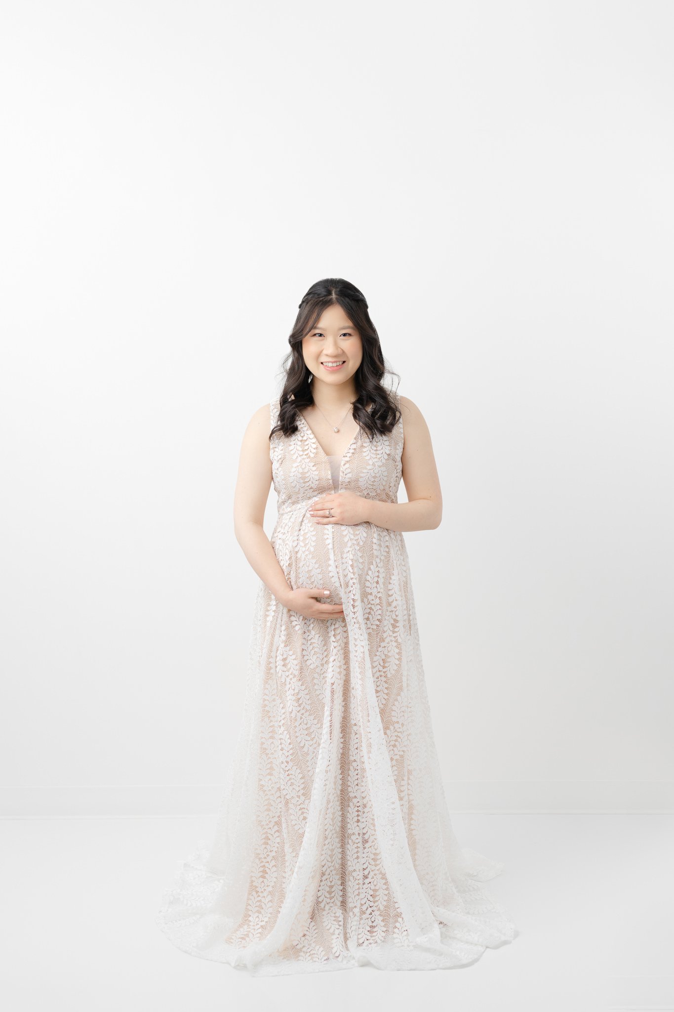  New Jersey maternity photographer Nicole Hawkins Photography captures a stunning portrait of a pregnant mother in a white gauzy gown. maternity portrait style ideas studio all white #NicoleHawkinsPhotography #NicoleHawkinsMaternity #MaternityPhotogr