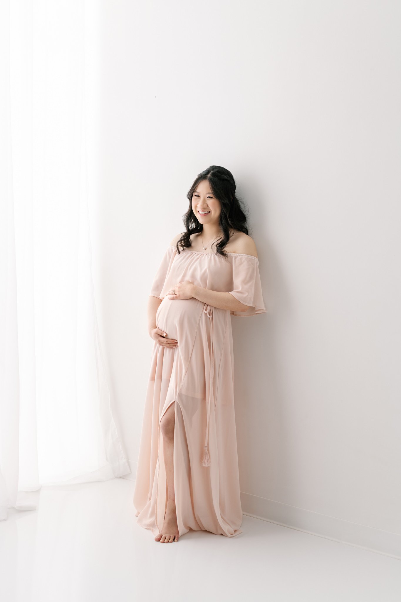  All-white studio maternity session for a modern maternity session portrait vibe by Nicole Hawkins Photography. modern maternity portraits pink gown white background #NicoleHawkinsPhotography #NicoleHawkinsMaternity #MaternityPhotography #Maternityst