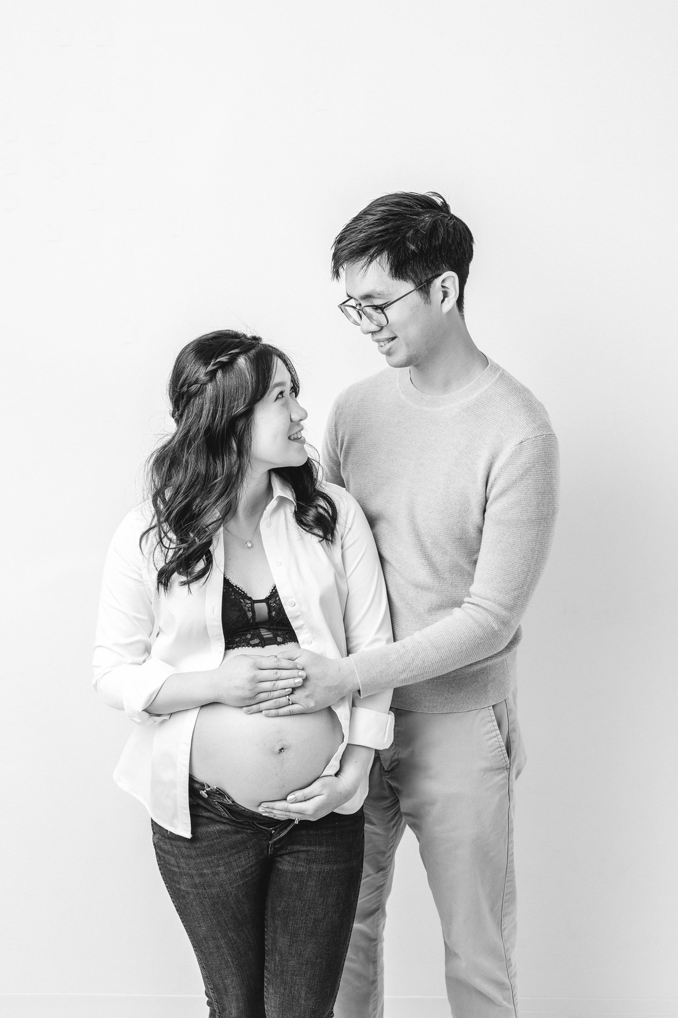  Husband and wife look lovingly at one another while both feel the baby in the womb by Nicole Hawkins Photography. husband and wife ready for baby #NicoleHawkinsPhotography #NicoleHawkinsMaternity #MaternityPhotography #Maternitystyle #NJMaternity #T