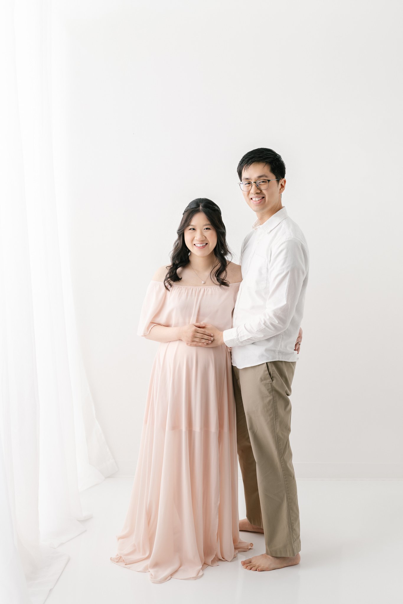  Studio maternity portraits in New Jersey with soon-to-be parents by Nicole Hawkins photography. pink maternity dress simple outfits for maternity #NicoleHawkinsPhotography #NicoleHawkinsMaternity #MaternityPhotography #Maternitystyle #NJMaternity #T