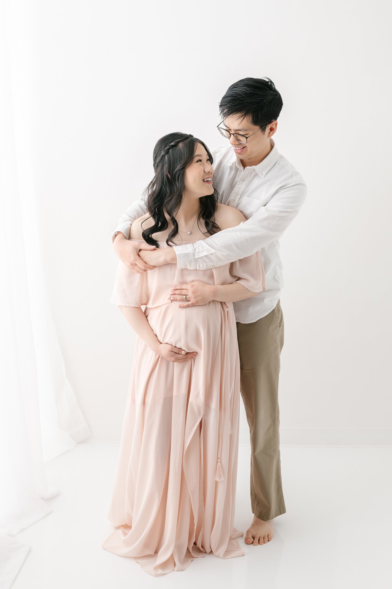  A husband wraps his arms around his wife loving her by Nicole Hawkins PHotgrpahy during a maternity session. husband holding his pregnant wife #NicoleHawkinsPhotography #NicoleHawkinsMaternity #MaternityPhotography #Maternitystyle #NJMaternity #Time