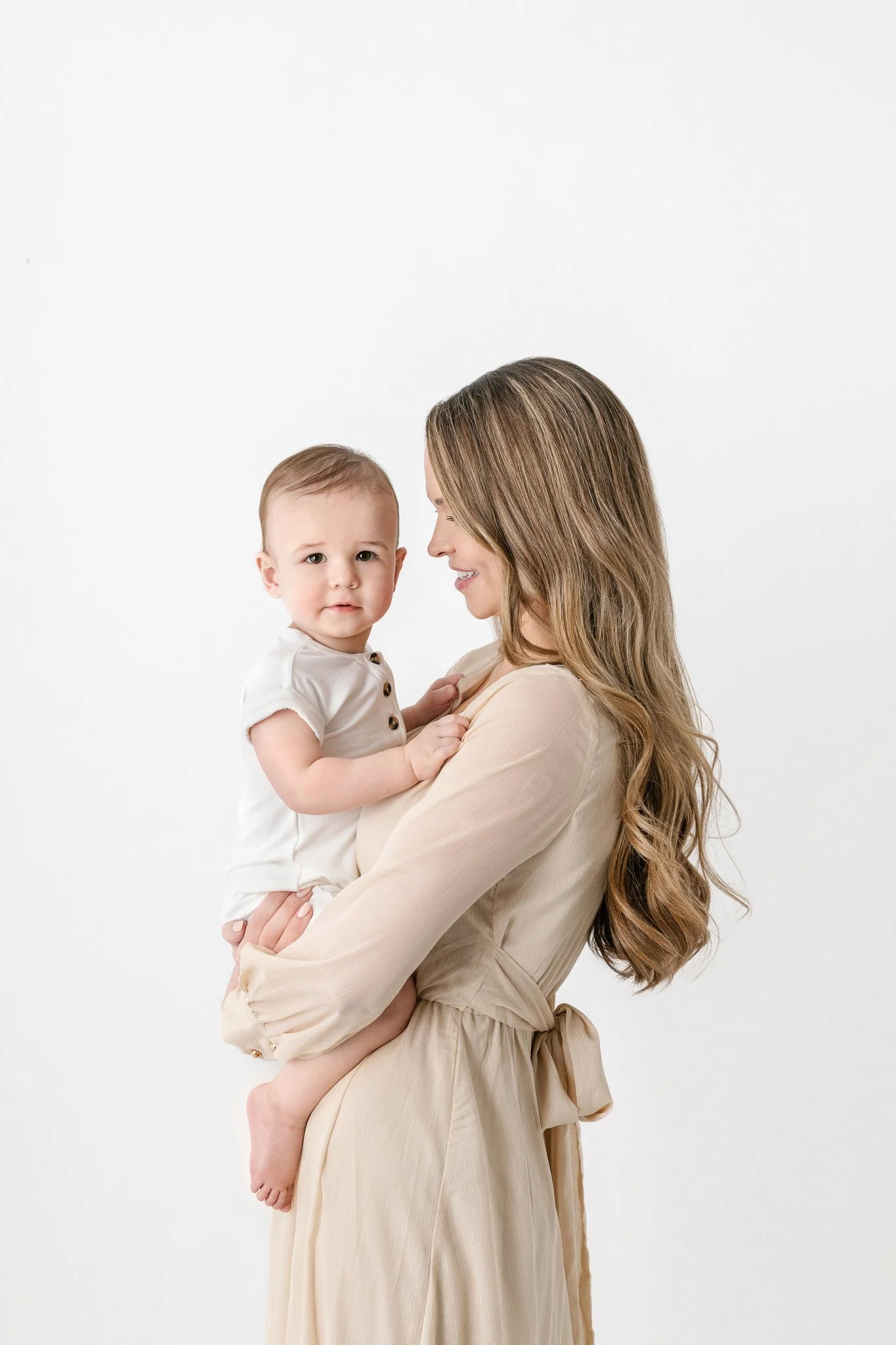  A mother holds her baby boy in her arms during a studio birthday session with Nicole Hawkins Photography in NJ. mother and boy studio portraits #NicoleHawkinsPhotography #NicoleHawkinsBabies #FirstBirthdayPhotography #StudioFamilyPortraits #NJBabies