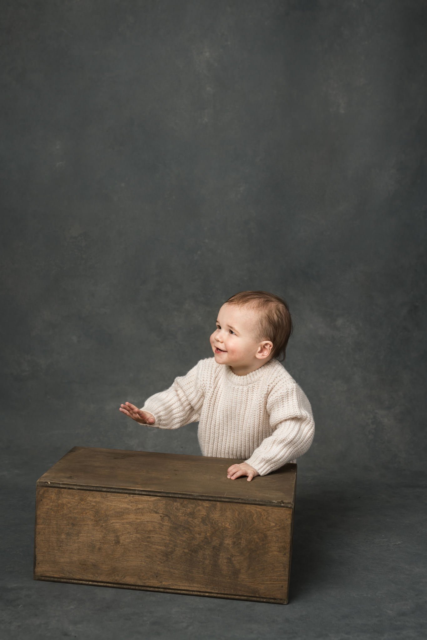  One-year-old baby boy takes portraits at a studio with a black background with Nicole Hawkins PHotogrpahy in Northern NJ. one year old portraits studio baby portraits #NicoleHawkinsPhotography #NicoleHawkinsBabies #FirstBirthdayPhotography #StudioFa