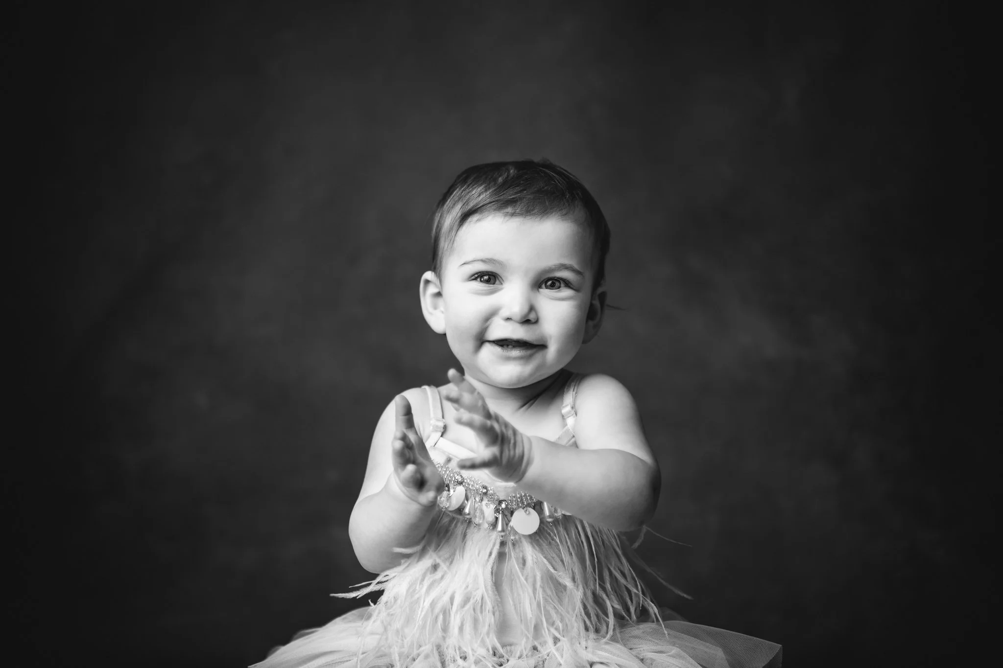  Black and white portrait of a little girl clapping her hands at a studio by Nicole Hawkins Photography. hand clap baby little girl inspiration baby girl first birthday ideas #NicoleHawkinsPhotography #NicoleHawkinsBabies&amp;Children #FirstBirthdayP