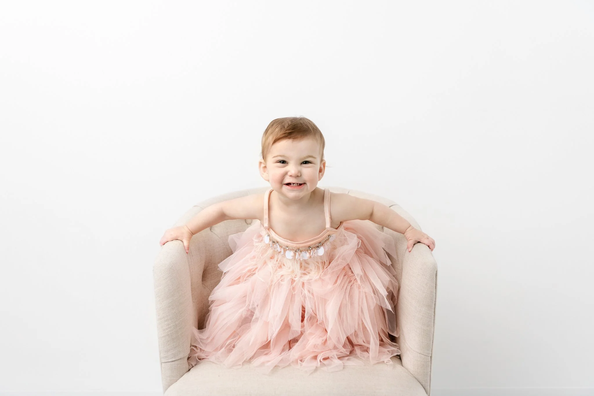  Child and Baby studio photographer Nicole Hawkins Photography captures a little girl jumping on a chair. baby girl playing candid baby moments authentic baby portraits #NicoleHawkinsPhotography #NicoleHawkinsBabies&amp;Children #FirstBirthdayPhotogr