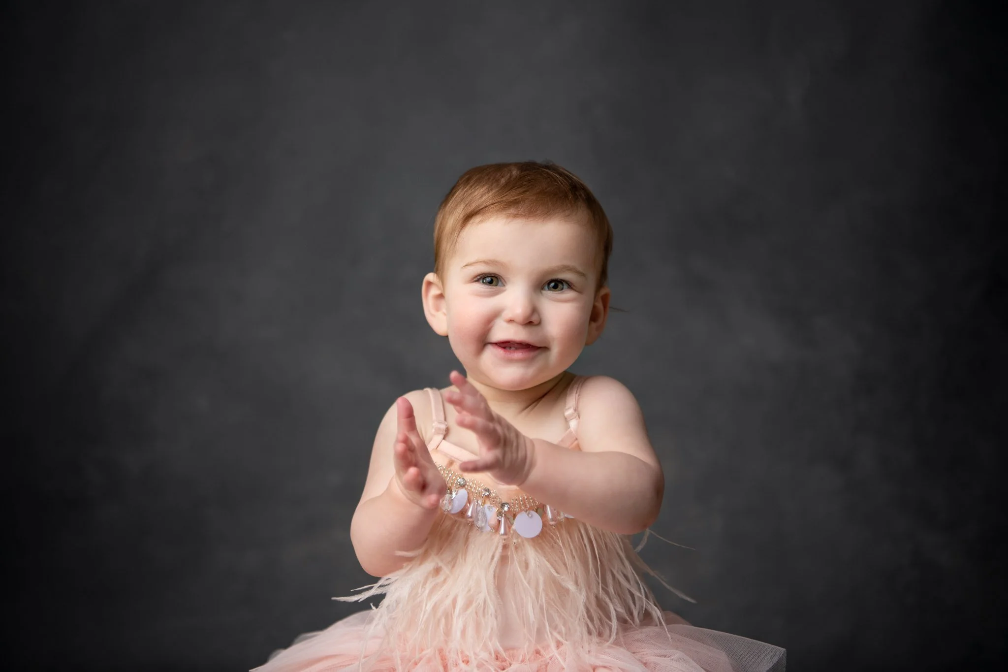  Nicole Hawkins Photography captures a baby girl wearing a flapper-style dress and clapping her hands. 20's baby dress 1920's baby girl dress first birthday New Jersey #NicoleHawkinsPhotography #NicoleHawkinsBabies&amp;Children #FirstBirthdayPhotogra
