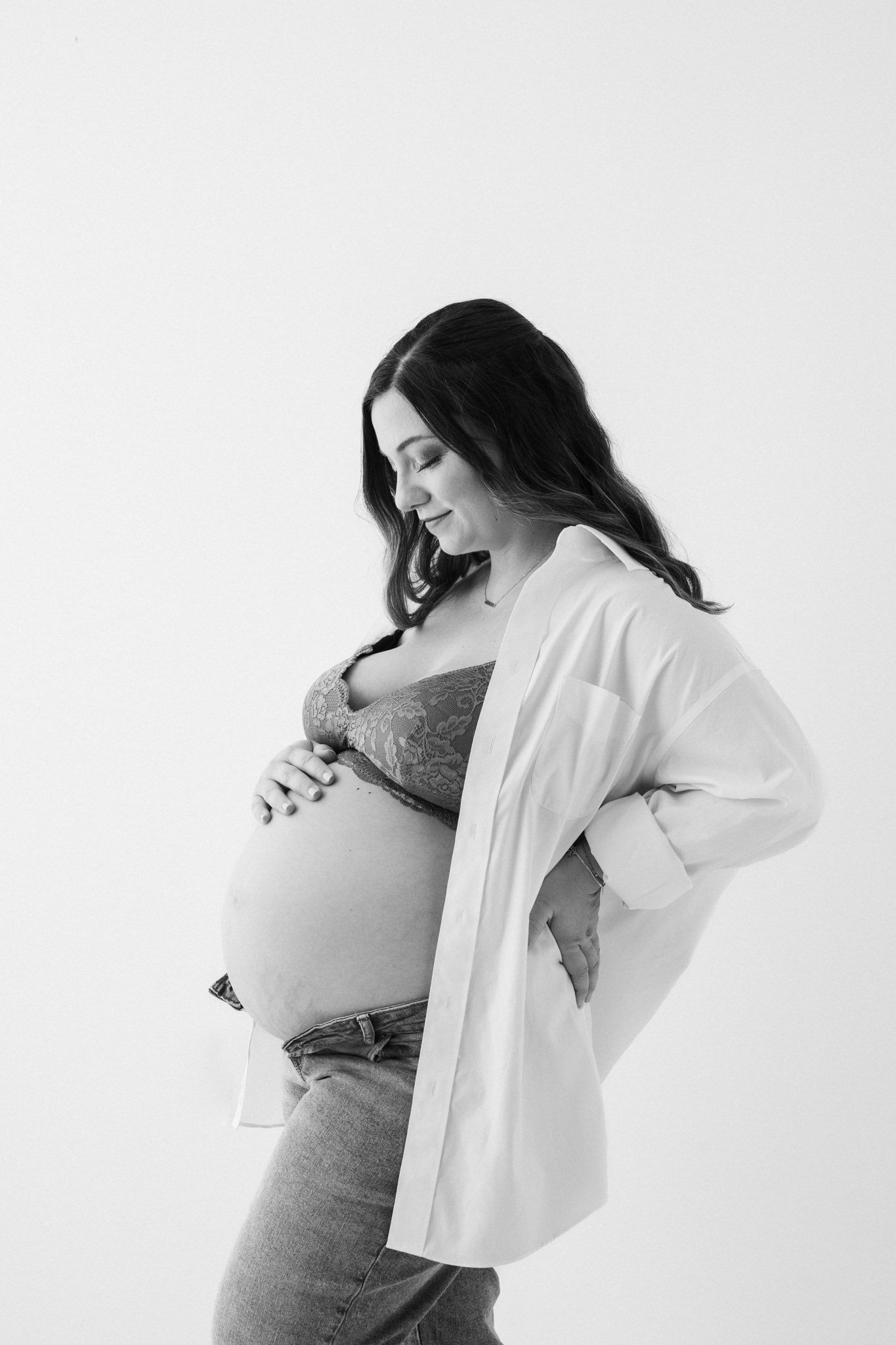  Stunning profile photograph of a woman holding her baby belly bump by Nicole Hawkins Photography. profile maternity portrait NJ #NicoleHawkinsPhotography #NicoleHawkinsMaternity #Babyontheway #studiomaternityNJ #whitestudiomaternityportraits #NYmate