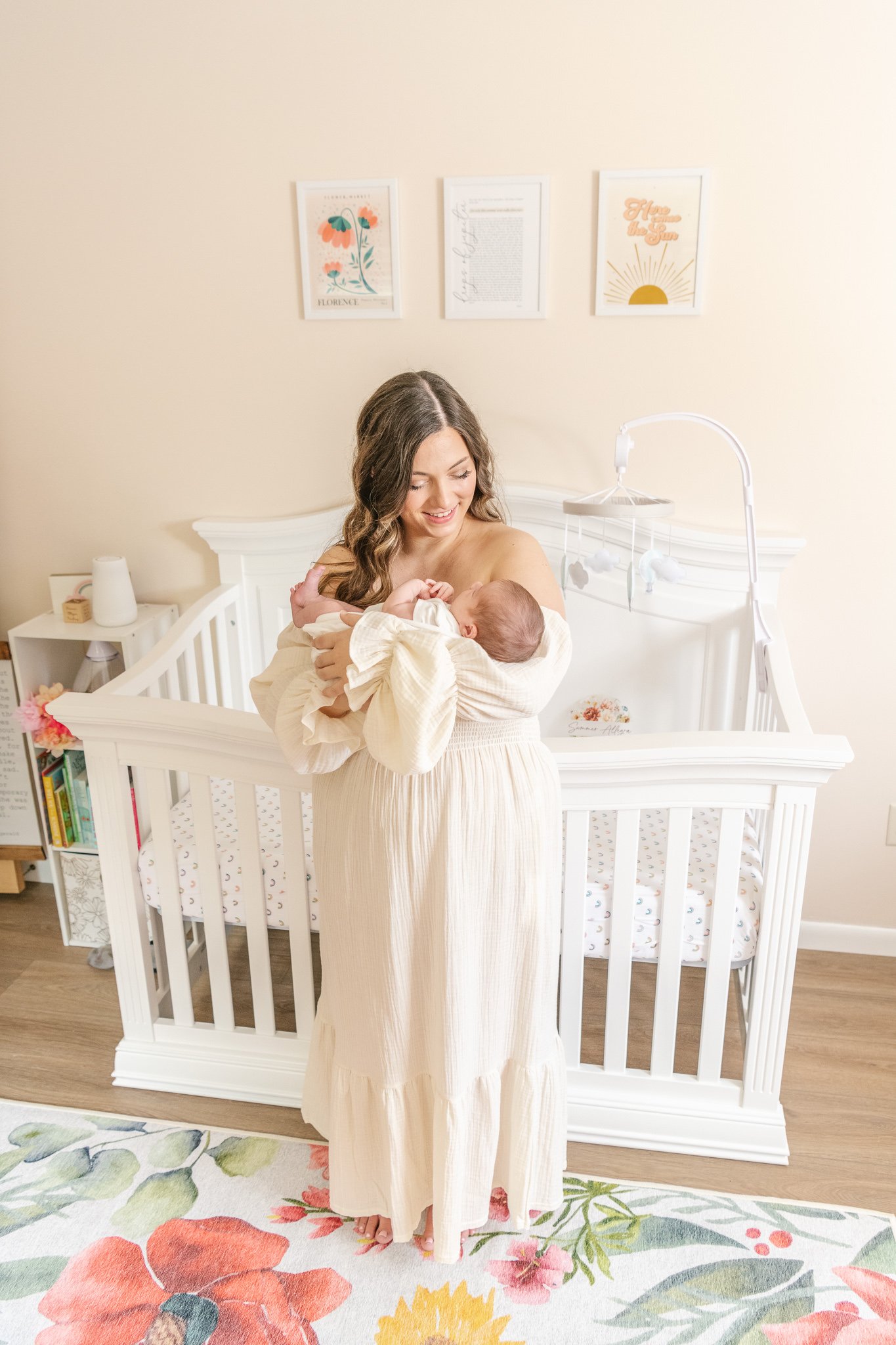  A mother standing in the middle of a baby nursery rocking her baby captured by Nicole Hawkins Photography in New Jersey. mother rocking her newborn in home newborns #NicoleHawkinsPhotography #NicoleHawkinsNewborns #Babygirl #inhomenewbornsNJ #homene