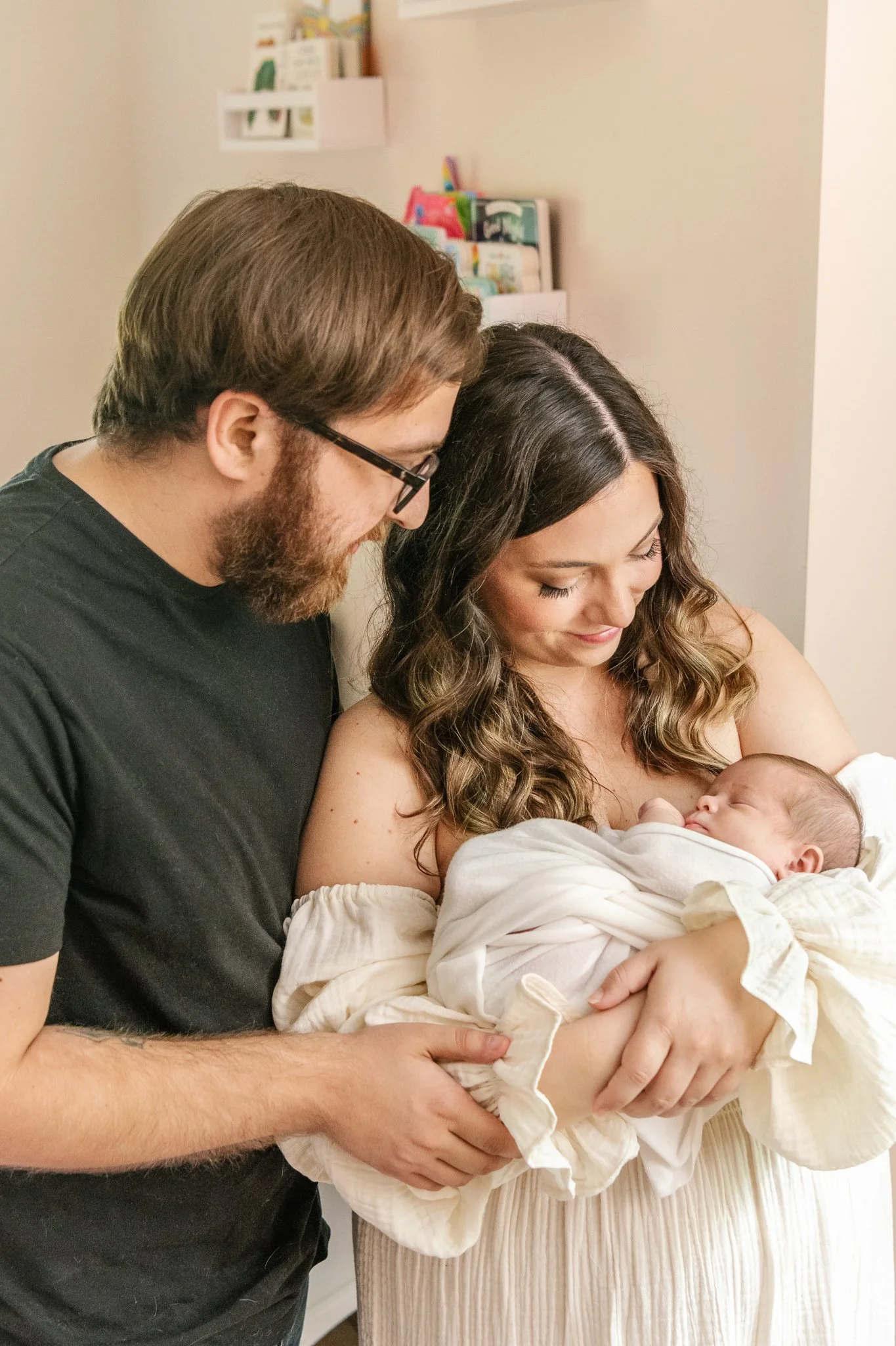  A new family of three with a newborn baby all snuggle together by Nicole Hawkins Photography in the NJ area. new parents newborn family portrait #NicoleHawkinsPhotography #NicoleHawkinsNewborns #Babygirl #inhomenewbornsNJ #homenewbonportraits #inhom