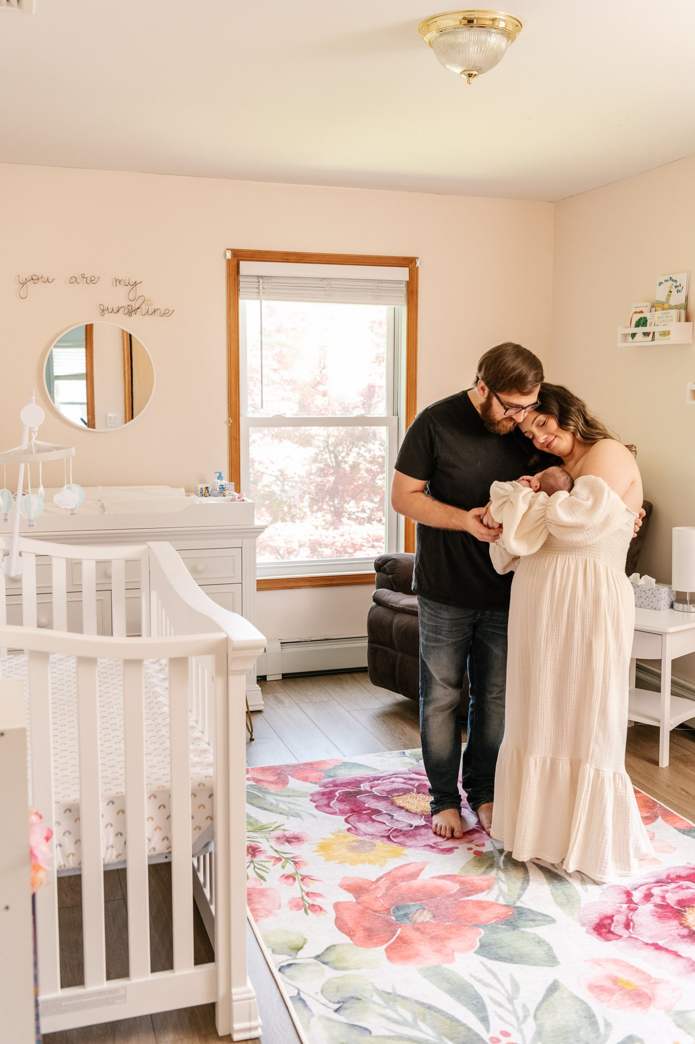  An intimate family moment is captured with new parents and babies in a little girl’s nursery by Nicole Hawkins Photography. candid newborn portraits tender family portrait with baby #NicoleHawkinsPhotography #NicoleHawkinsNewborns #Babygirl #inhomen