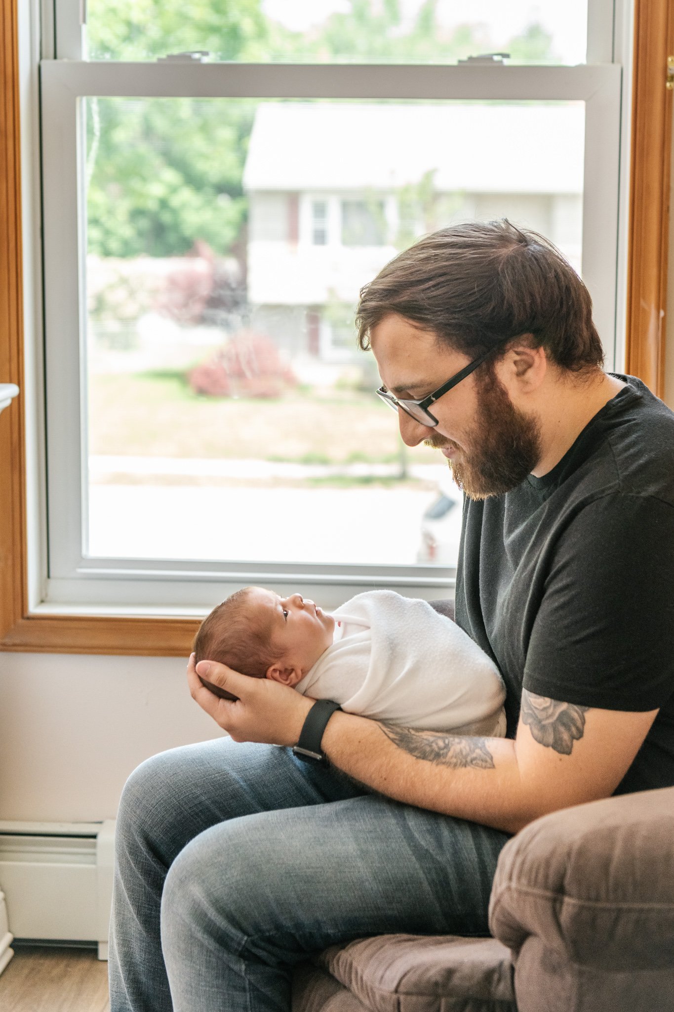  During an in-home newborn session, a father rocks his baby in a recliner by Nicole Hawkins Photography. father rocking baby girl newborn baby #NicoleHawkinsPhotography #NicoleHawkinsNewborns #Babygirl #inhomenewbornsNJ #homenewbonportraits #inhomene