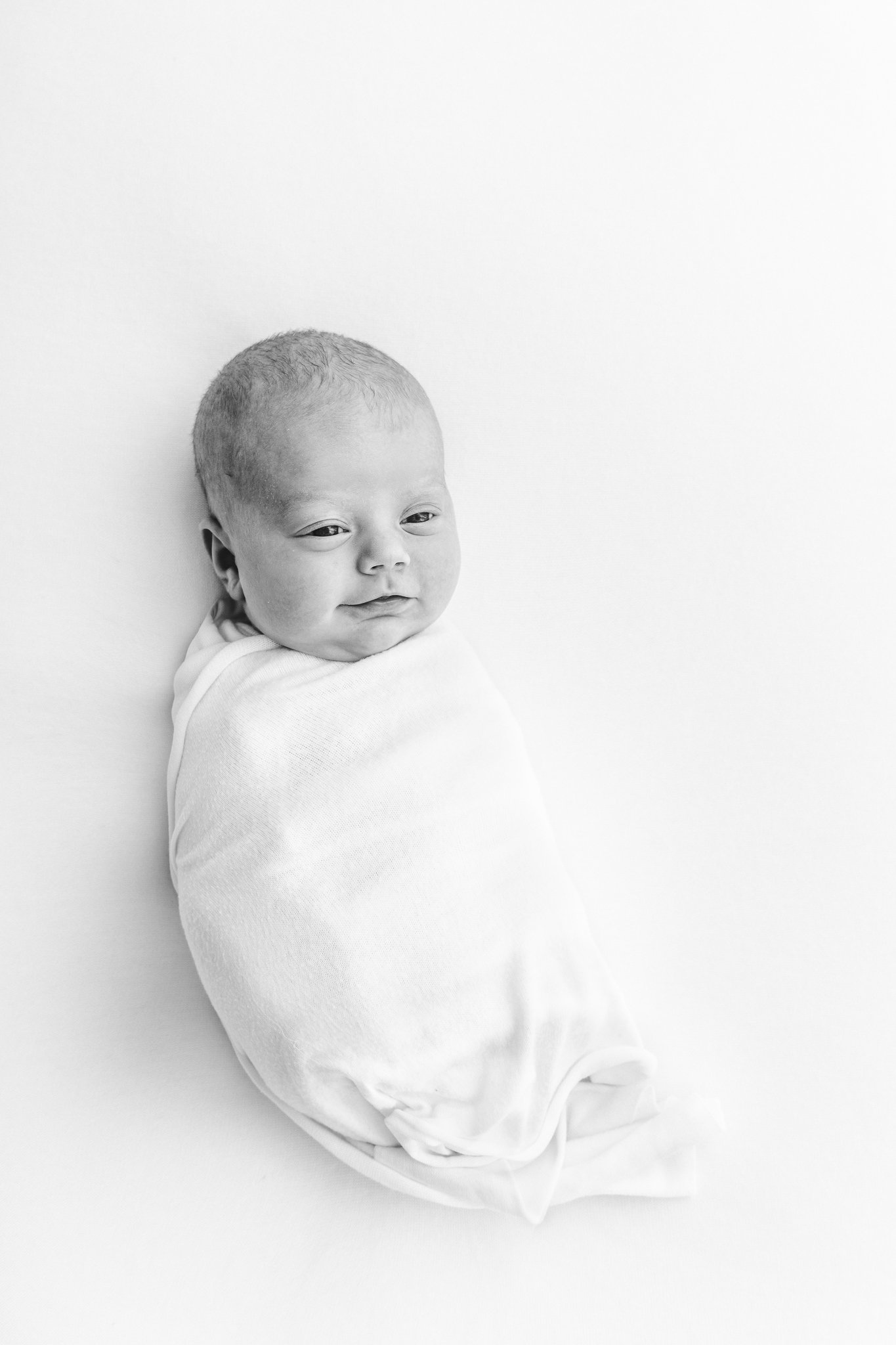  A black and white portrait of a newborn baby by Nicole Hawkins Photography at a New Jersey studio. NJ studio portraits high-end studio portraits modern newborns #NicoleHawkinsPhotography #NicoleHawkinsNewborns #StudioNewborn #StudioFamily #EastCoast