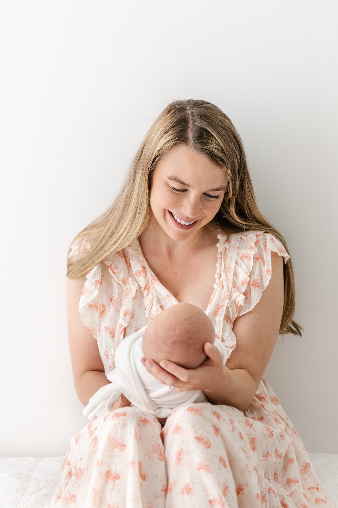  Blonde mother looks lovingly down at her baby girl by Nicole Hawkins Photography a studio family photographer. mother newborn fresh 48 studio portraits #NicoleHawkinsPhotography #NicoleHawkinsNewborns #StudioNewborn #StudioFamily #EastCoastNewbornPh