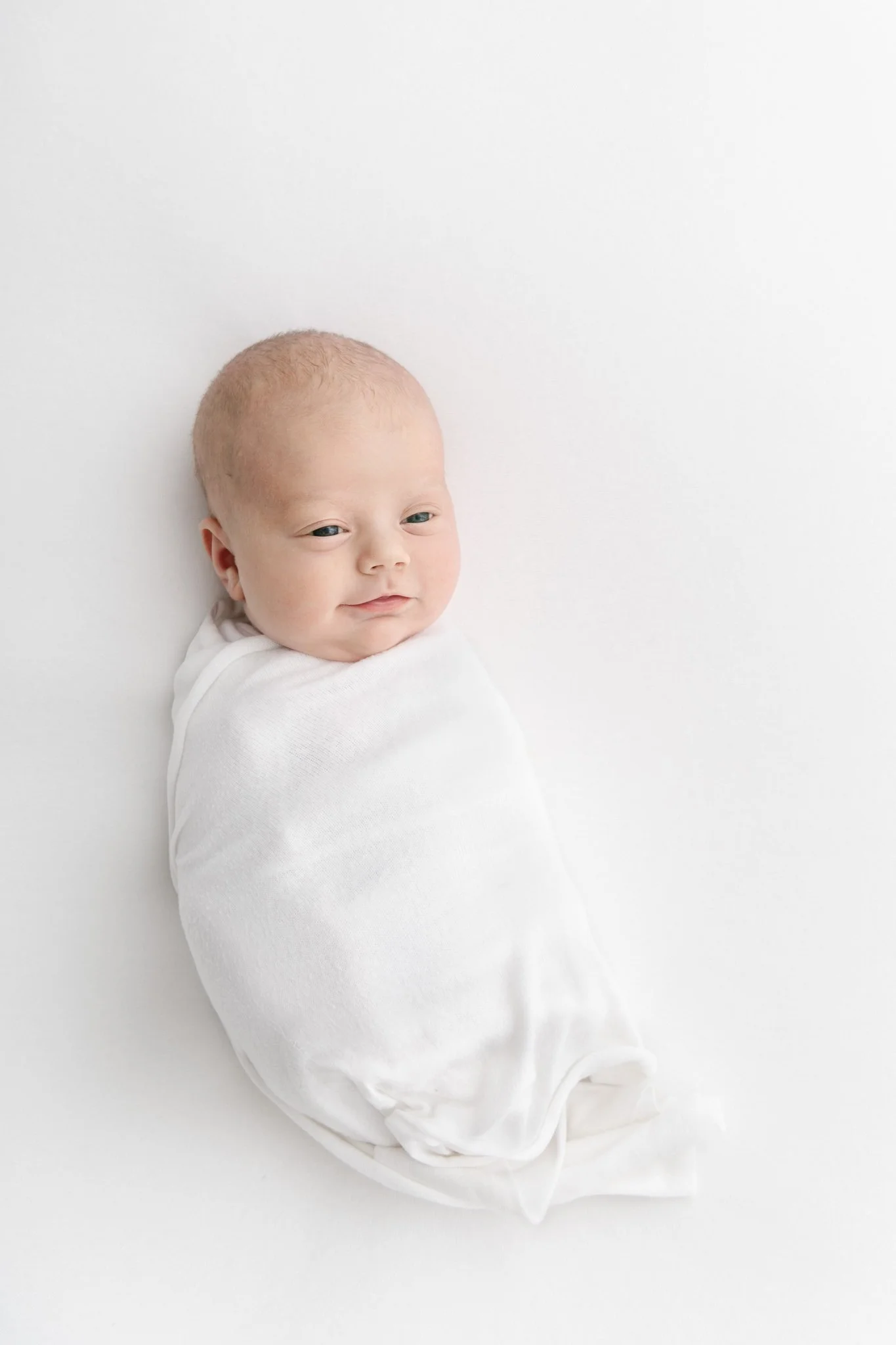  Swaddled baby girl sleeping in a white studio in New Jersey by Nicole Hawkins Photography. swaddled newborn studio NJ newborns #NicoleHawkinsPhotography #NicoleHawkinsNewborns #StudioNewborn #StudioFamily #EastCoastNewbornPhotographer #NewJerseyNewb