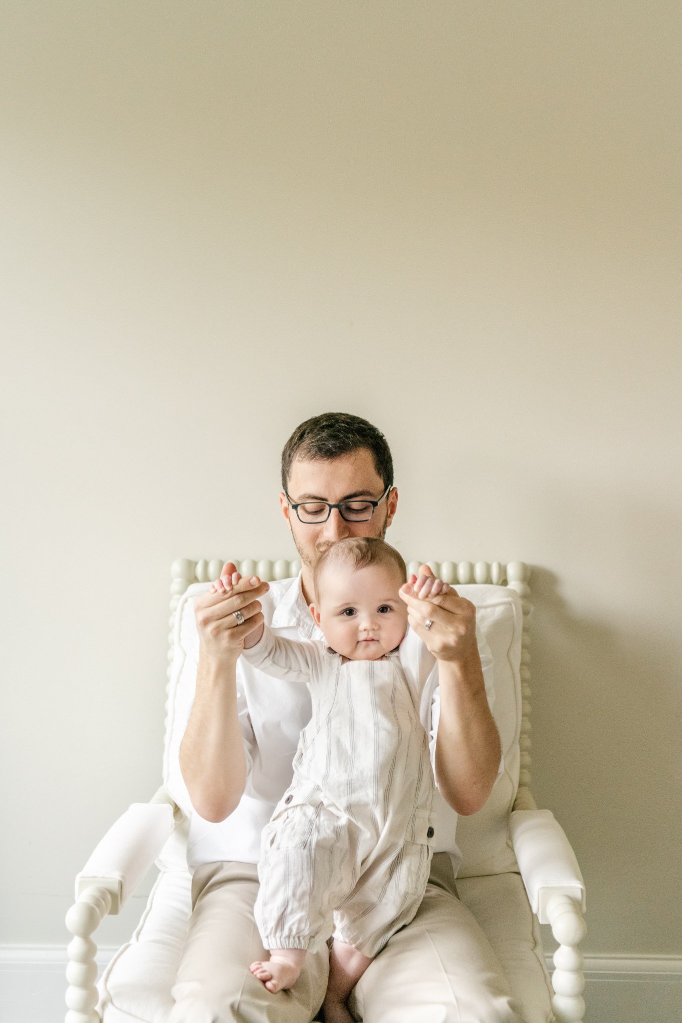  A daddy-daughter portrait captured at a home in South Orange, NJ by Nicole Hawkins Photography. baby girl sitting with dad NJ family portraits #NicoleHawkinsPhotography #NicoleHawkinsfamilies #AtHomePortraits #EastCoastFamilyPhotographer #NewJerseyI