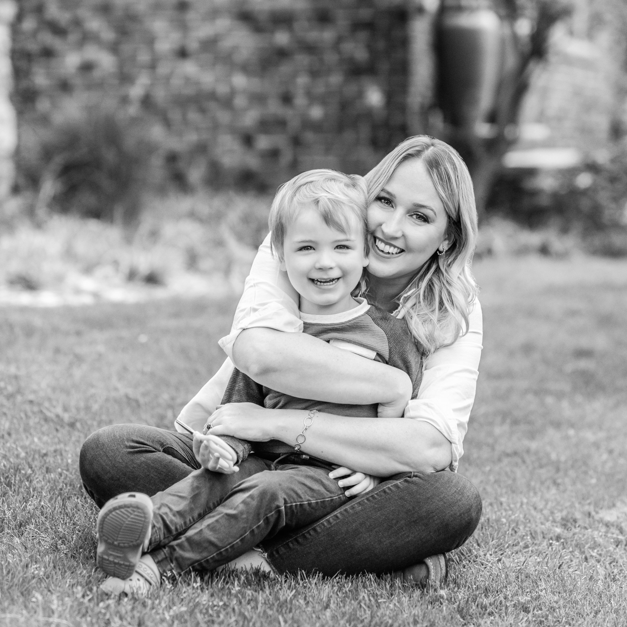  Black and white family portrait of a mother and her little boy sitting in their own yard by Nicole Hawkin Photography. mother and son portrait east coast family #NicoleHawkinsPhotography #NicoleHawkinsfamilies #AtHomePortraits #EastCoastFamilyPhotog
