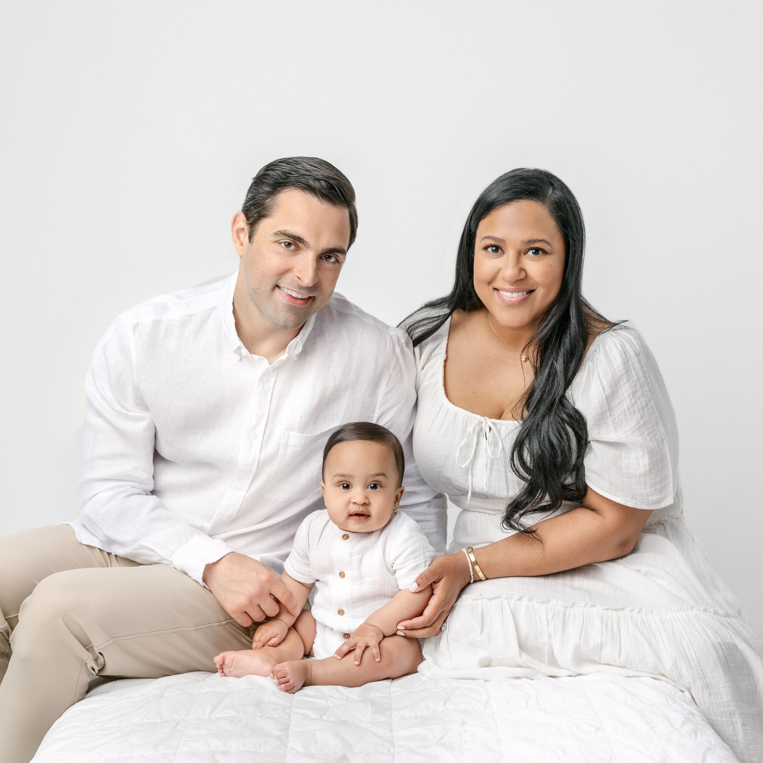  A family dressed in an all-white smile for a family portrait by Nicole Hawkins Photography, a professional studio family photographer. Family studio photography NJ #NicoleHawkinsPhotography #NicolewHawkinsChildren #NewJerseyStudioBabies #StudioNewbo