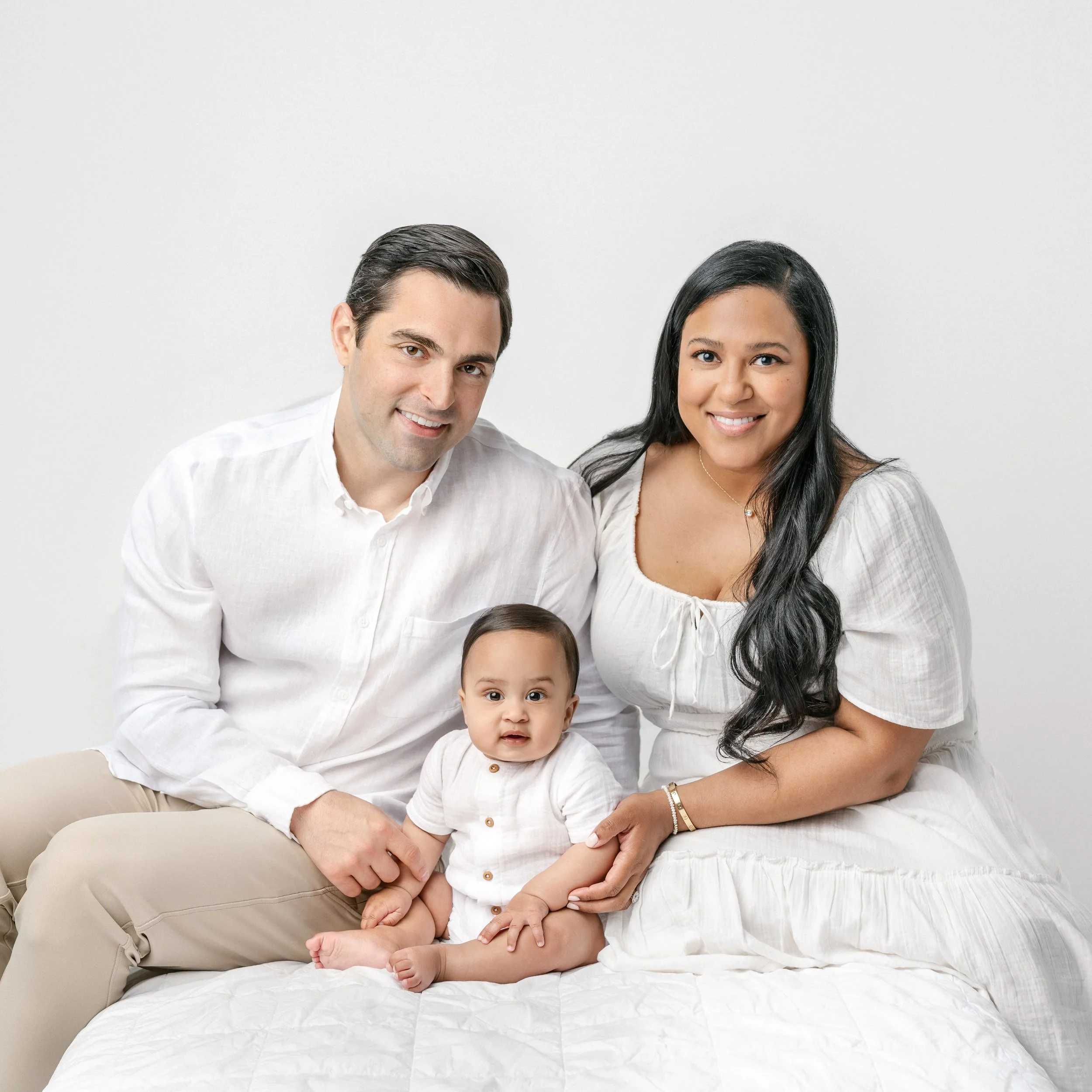  A family dressed in an all-white smile for a family portrait by Nicole Hawkins Photography, a professional studio family photographer. Family studio photography NJ #NicoleHawkinsPhotography #NicolewHawkinsChildren #NewJerseyStudioBabies #StudioNewbo