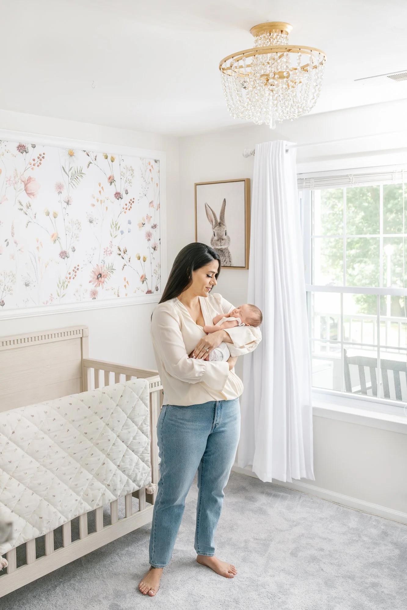 In a luxurious nursery adorned with timeless floral wallpaper, a young mother cradles her newborn. Nicole Hawkins Photography beautifully captures this intimate in-home newborn portrait session. #centralNewJerseyphotographer #inhomeportraits #newbor