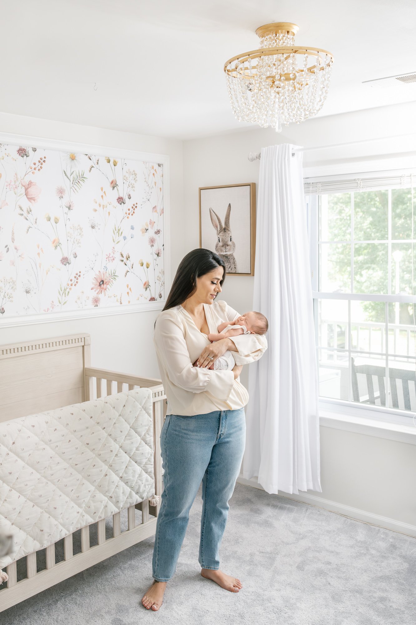  In a luxurious nursery adorned with timeless floral wallpaper, a young mother cradles her newborn. Nicole Hawkins Photography beautifully captures this intimate in-home newborn portrait session. #centralNewJerseyphotographer #inhomeportraits #newbor