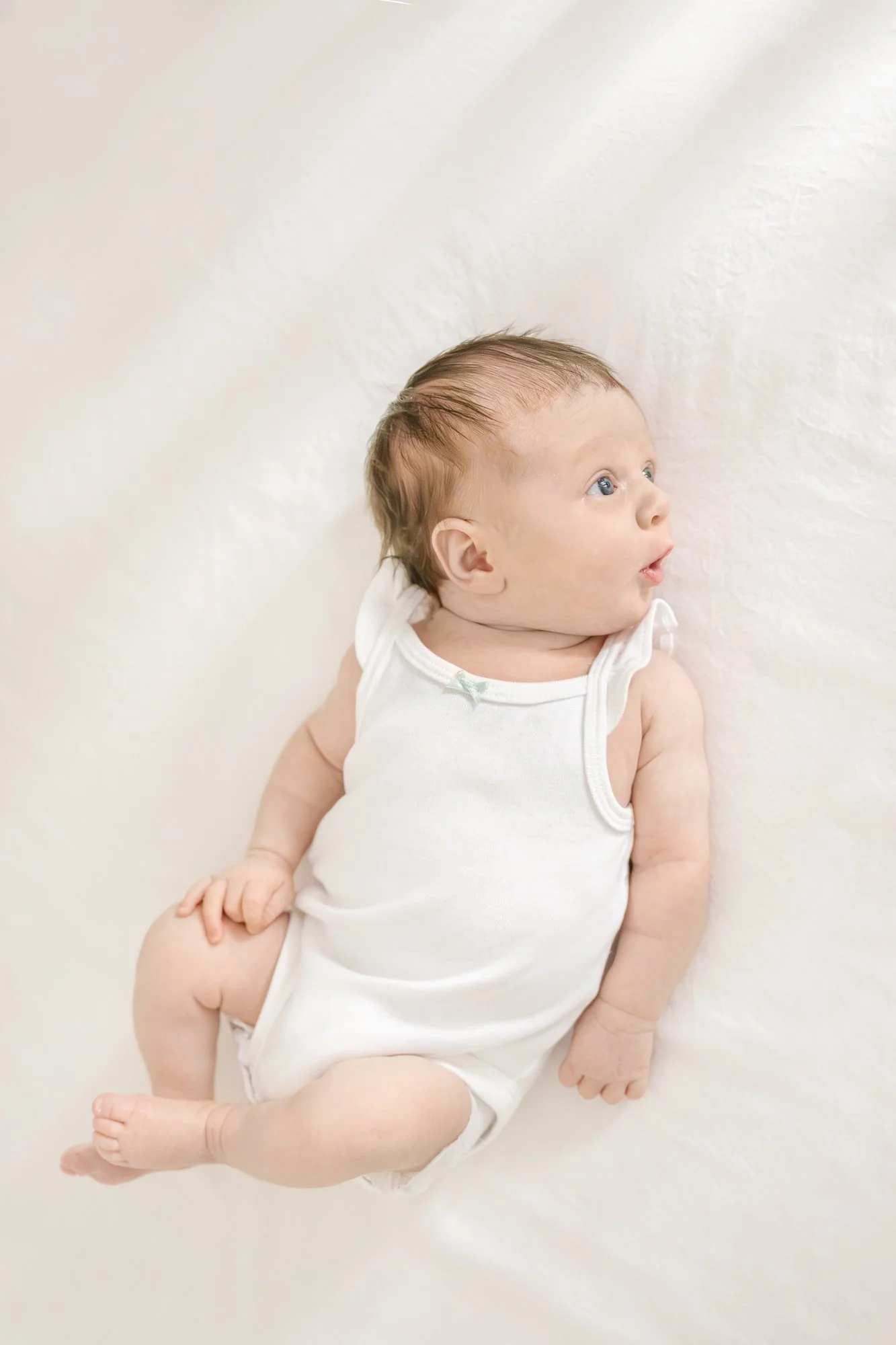 In the comfort of your home, Nicole Hawkins Photography, your North Central New Jersey Newborn Photographer, skillfully captures a precious, scrunched newborn face, ensuring timeless memories that will last a lifetime. #centralNewJerseyphotographer 