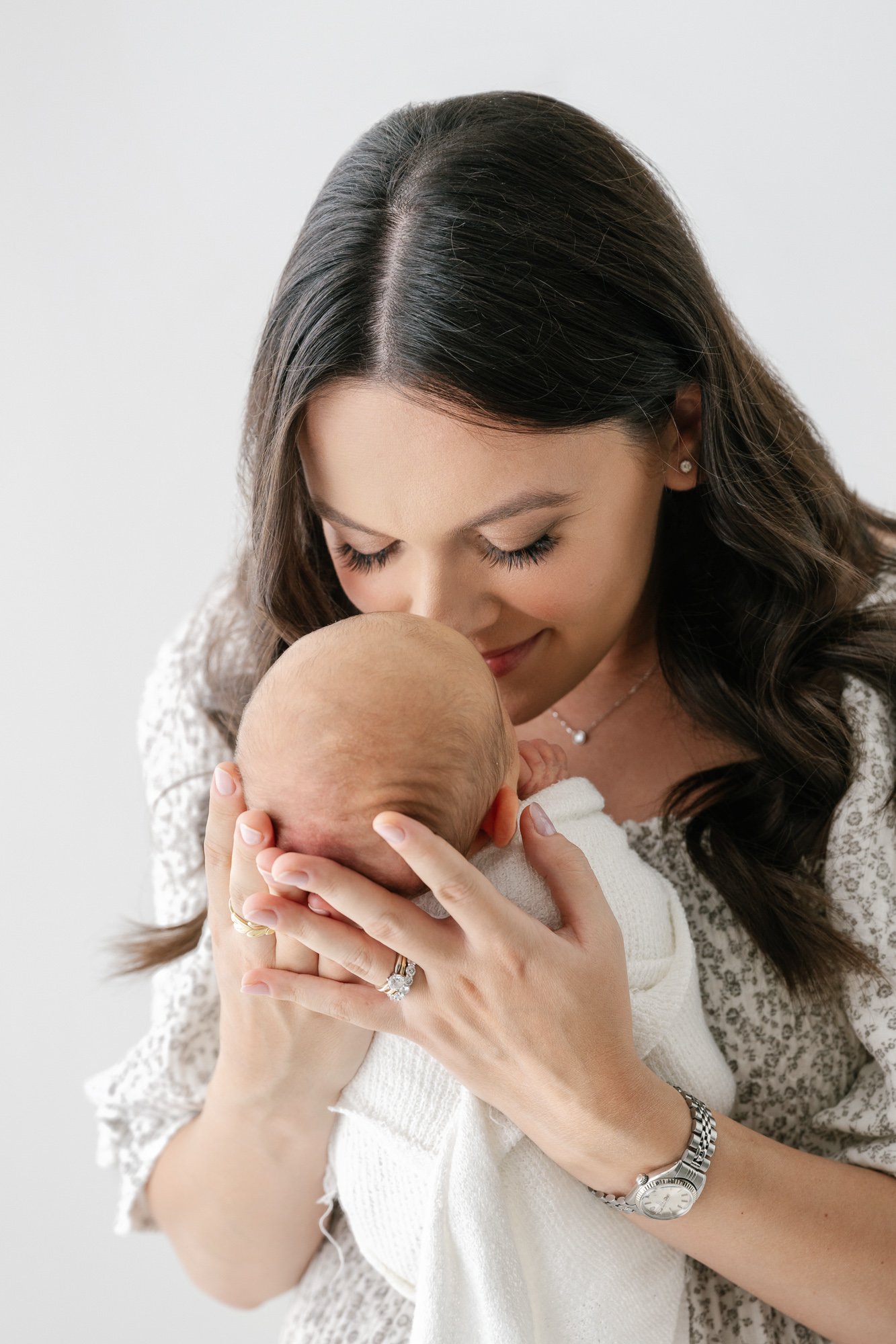  Tender moment captured by Nicole Hawkins Photography, a New Jersey based photographer: A mother leaning in close to her precious newborn, radiating love and affection. #NicoleHawkinsphotography #newbornportraits #NewJerseynewbornphotographer #NewJer