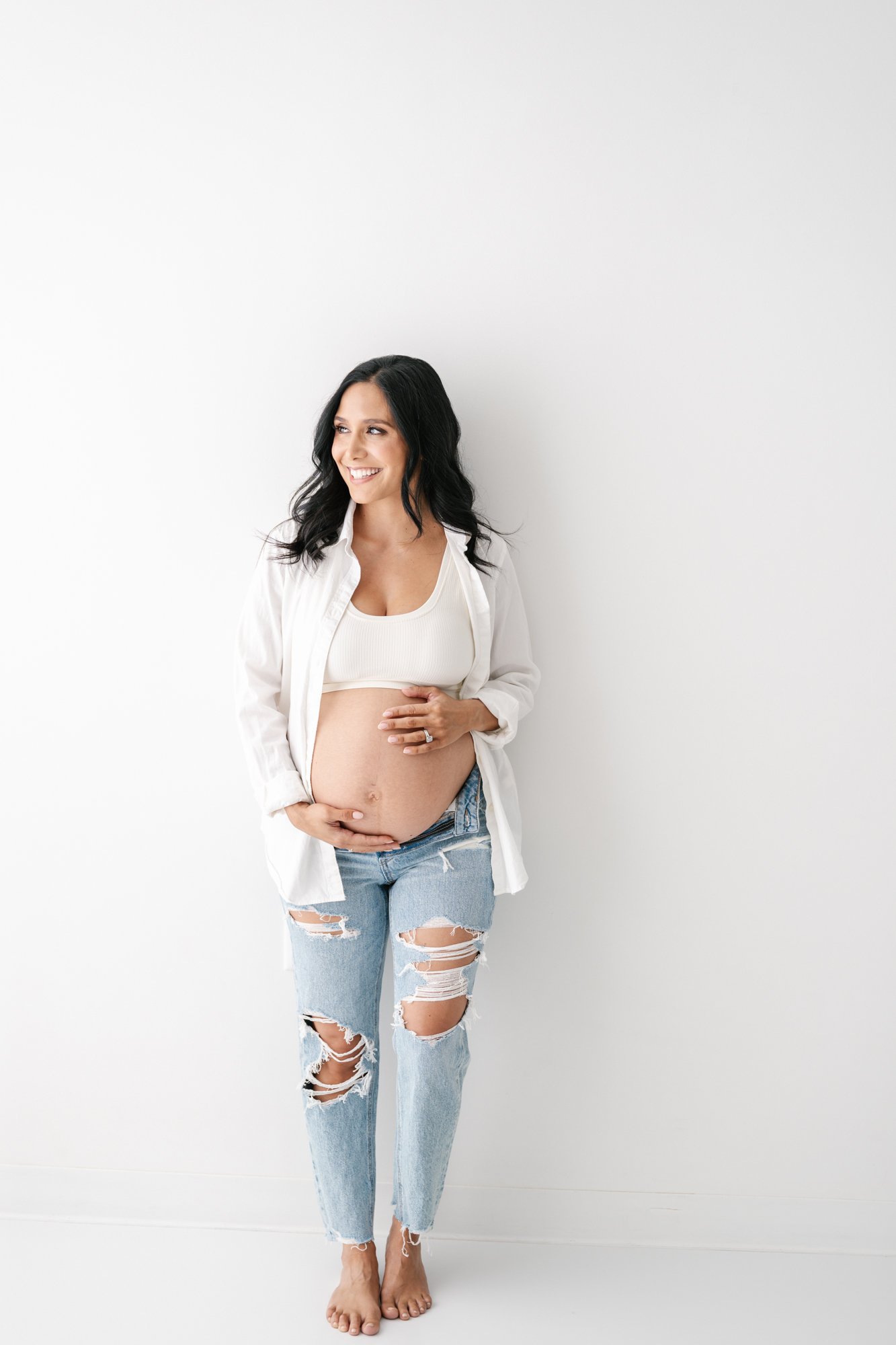  New Jersey mom takes photos for a maternity session with Nicole Hawkins to commemorate her final pregnancy in South Orange. #southorange #newjerseyphotographers #maternitysession #maternityposeinspo #studiophotography #formalmaternitystyle #casualma