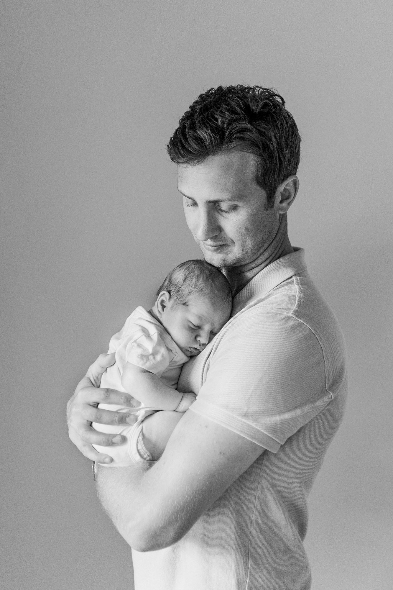  Sweet pose idea for a father and son portrait during an in-home newborn session in Short Hills, New Jersey with Nicole Hawkins Photography. #candidposeinspo #newbornphotography #shorthillsphotographer #familyphotographersinnewjersey #inhomeportraits