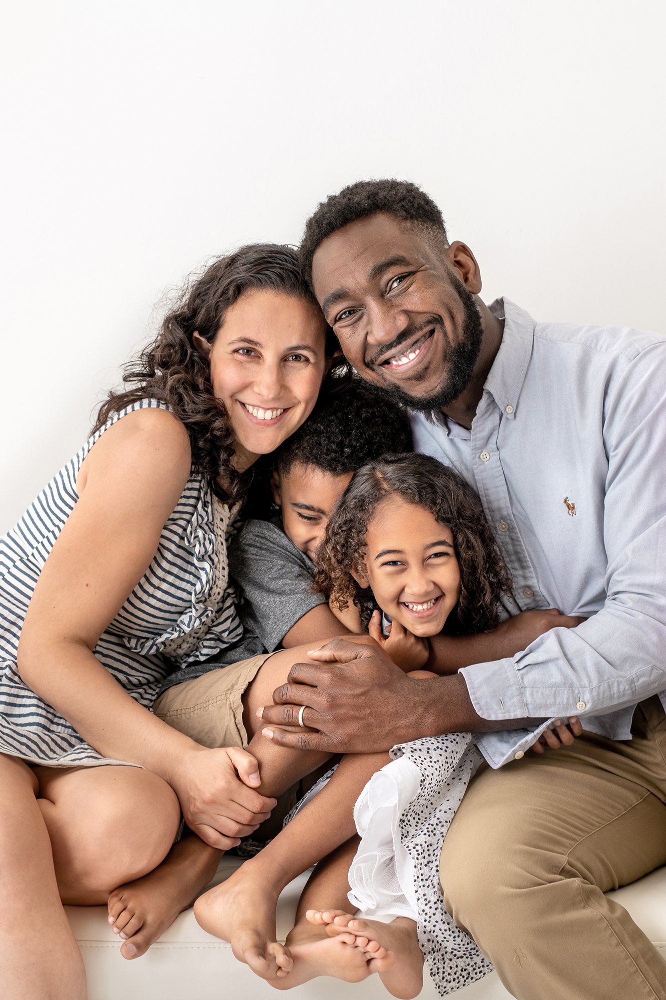   In-studio family portrait, family laughing and smiling at camera during family photos. Family photo pose suggestions posing family for family portrait #UnionCountyFamilyPhotographer #PassaicCountyFamilyPhotographer #NorthernNewJerseyFamilyPhotograp