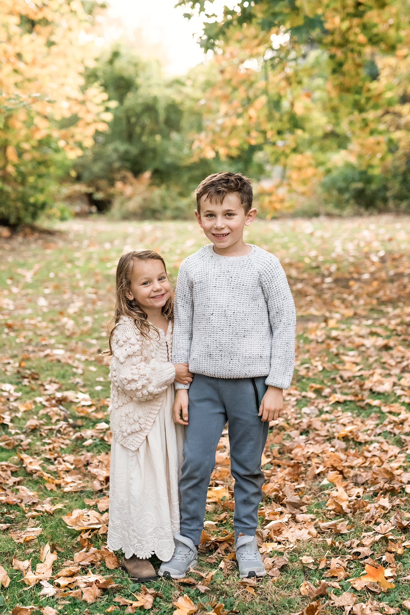   Brother and sister standing outside in a field during family photoshoot with Nicole Hawkins, Northern New Jersey photographer. Sibling photo posing ideas family photo posing ideas #UnionCountyFamilyPhotographer #MorrisCountyFamilyPhotographer #Nort