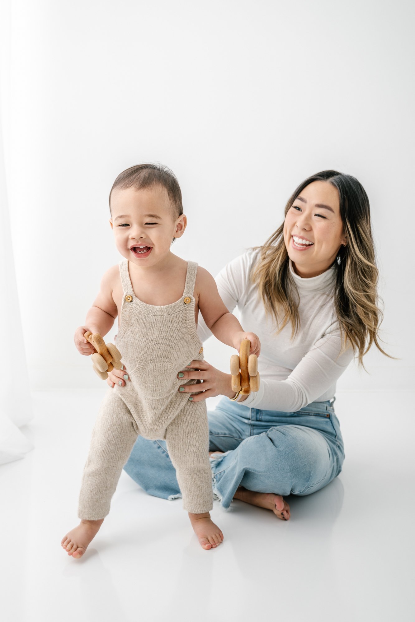   Photo of mom playing with toddler during casual studio family photoshoot. Mom and toddler posing ideas toddler portrait inspiration #EssexCountyFamilyPhotographer #BergenCountyFamilyPhotographer #NorthernNewJerseyFamilyPhotographer #ManhattanPhotog
