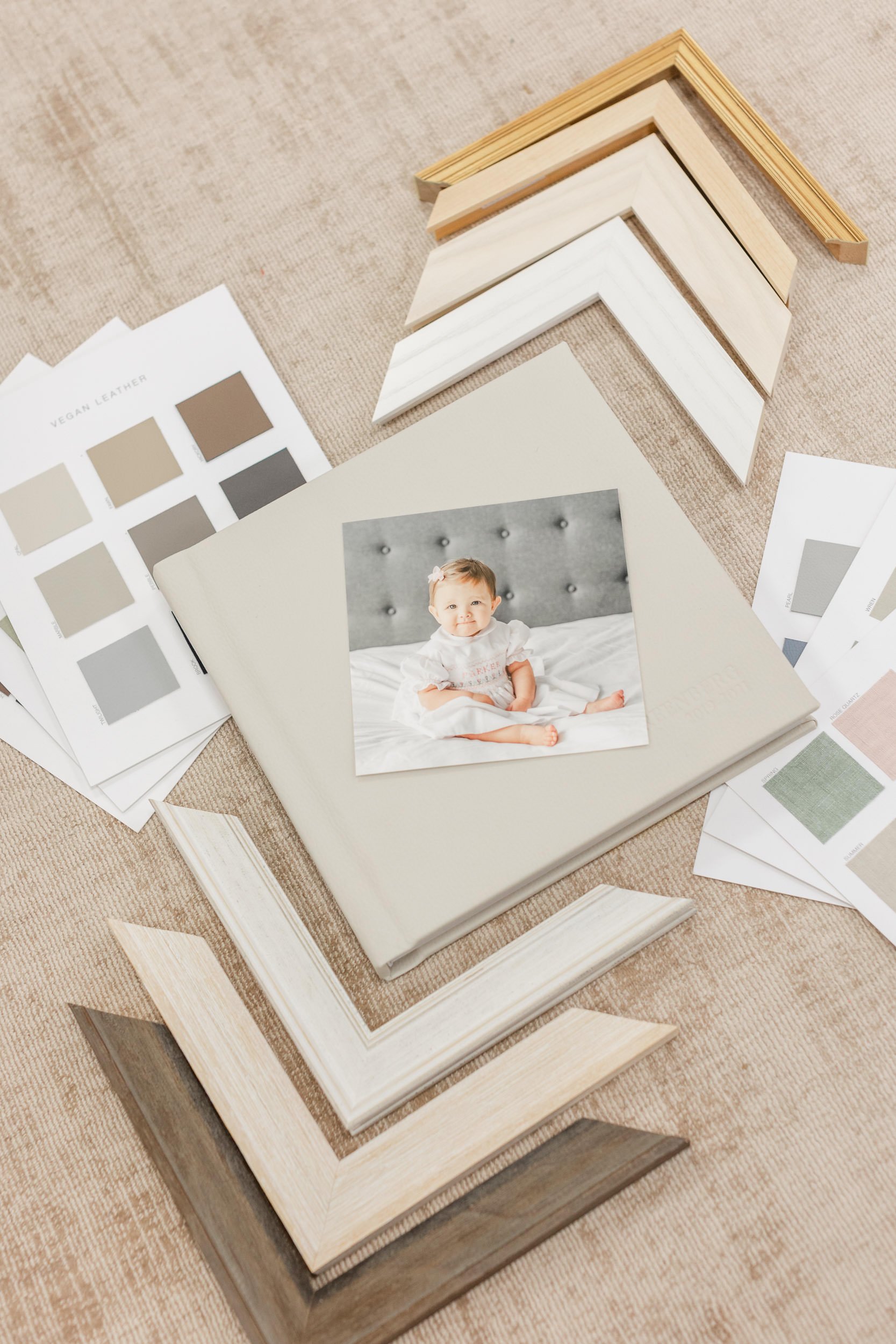   Framing options, including different colors and styles of frames, mats, and photobooks, with a photo of a baby girl. Framing family photos professional family portraits #EssexCountyFamilyPhotographer #BergenCountyFamilyPhotographer #ManhattanFamily