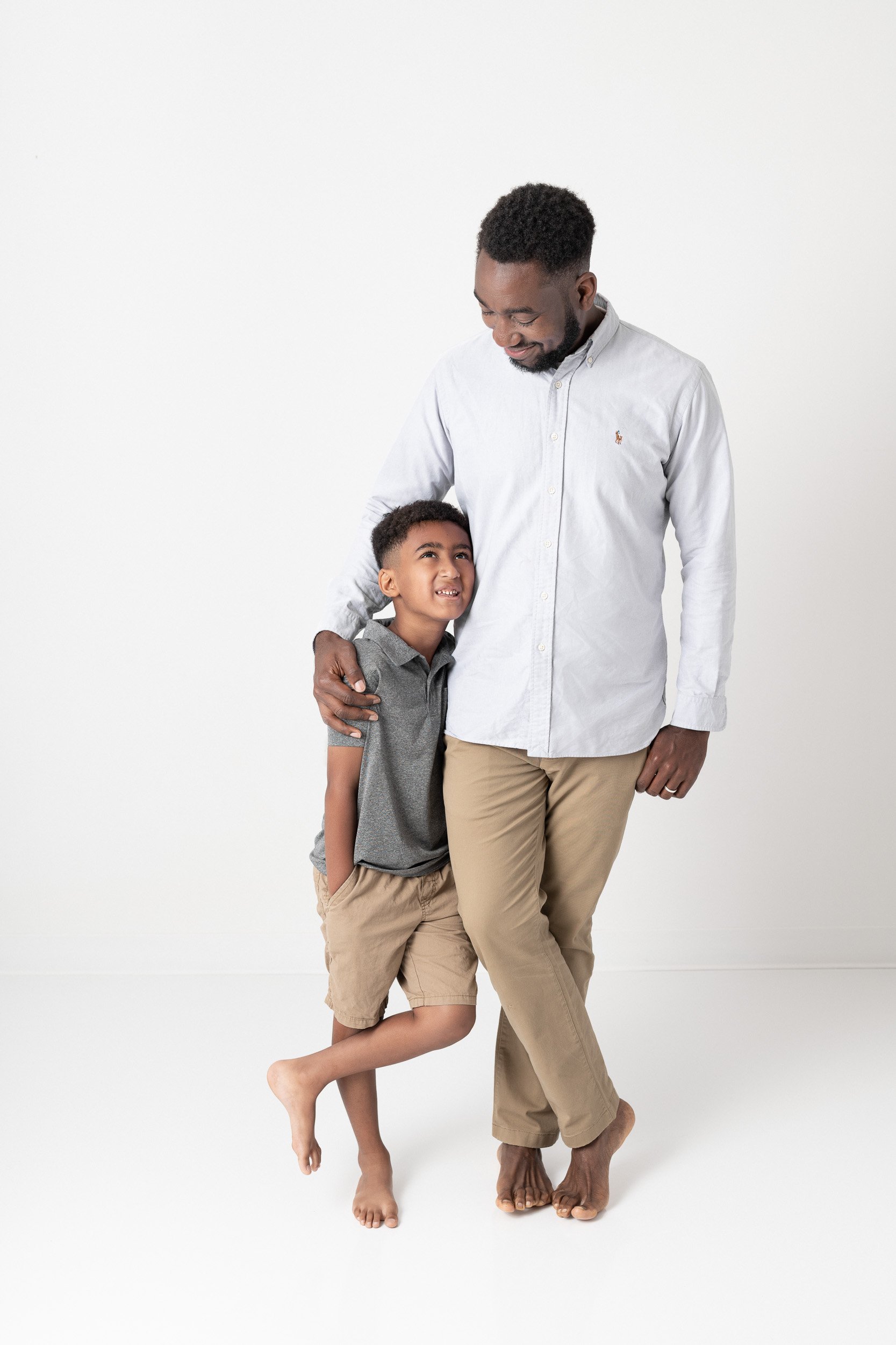   Father and son posing during in-studio family photoshoot, shot by Nicole Hawkins, New Jersey family photographer. Father son portrait ideas dad and son pose inspiration&nbsp; #UnionCountyFamilyPhotographer #MorrisCountyFamilyPhotographer #Manhattan
