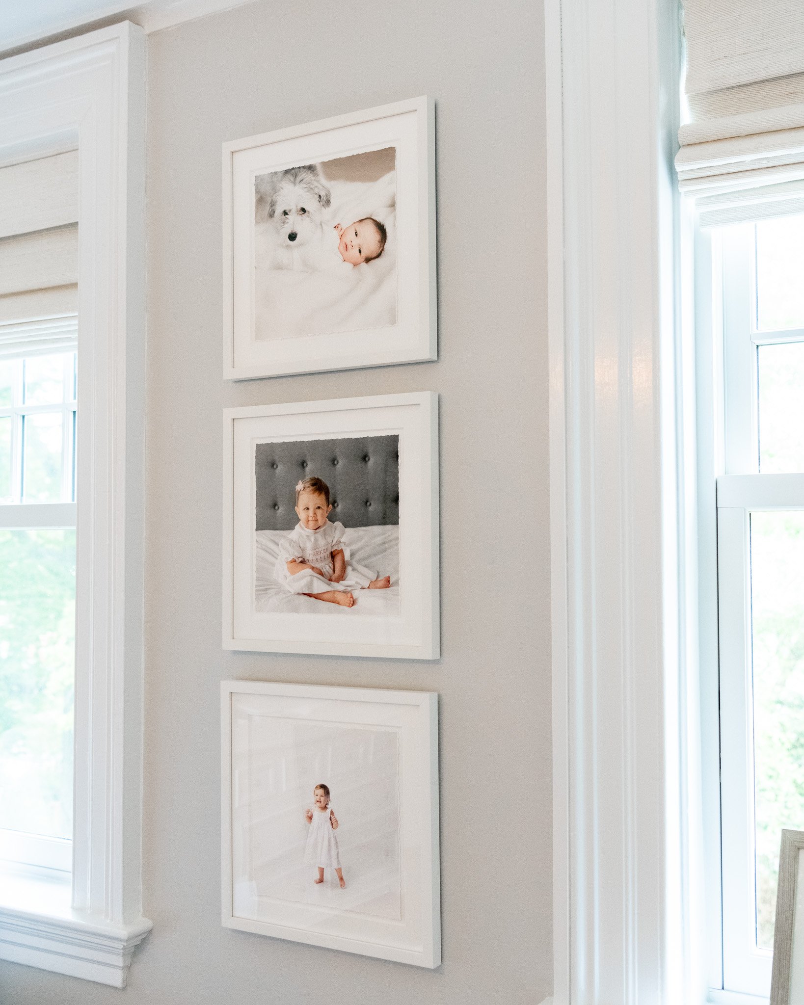   Nursery with three framed baby portraits hung vertically with white frames and mats. Gallery wall with three vertical prints in matching frames #EssexCountyFamilyPhotographer #MorrisCountyFamilyPhotographer #NorthernNewJerseyFamilyPhotographer #Nor