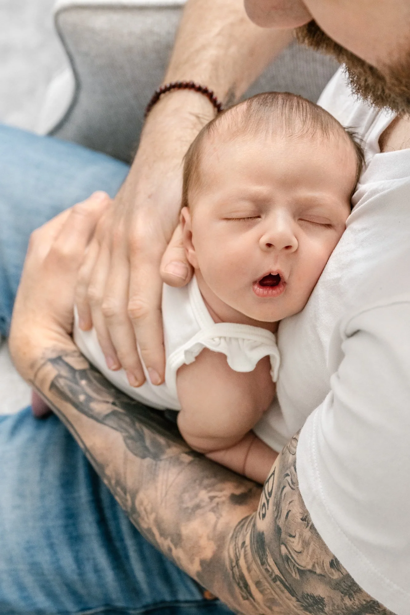   Closeup portrait of dad holding newborn baby girl sleeping with mouth open taken by newborn portrait photographer Nicole Hawkins. Closeup family portraits #EssexCountyFamilyPhotographer #MorrisCountyFamilyPhotographer #ManhattanFamilyPhotographer #