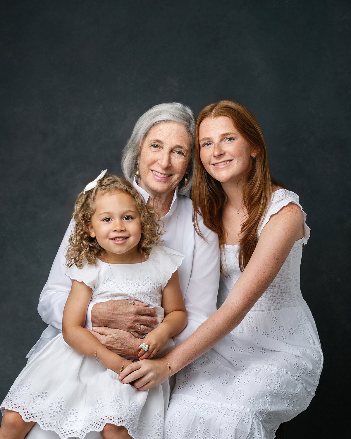 Grandmother_granddaughter_white_outfits_studio_portrait.jpg