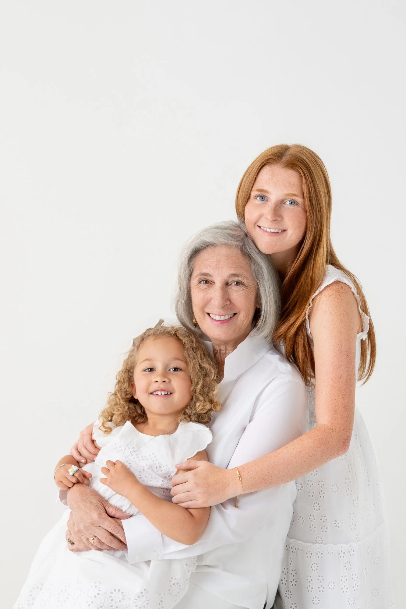 Grandmother-granddaughter-white-clothing-studio-portrait.jpg
