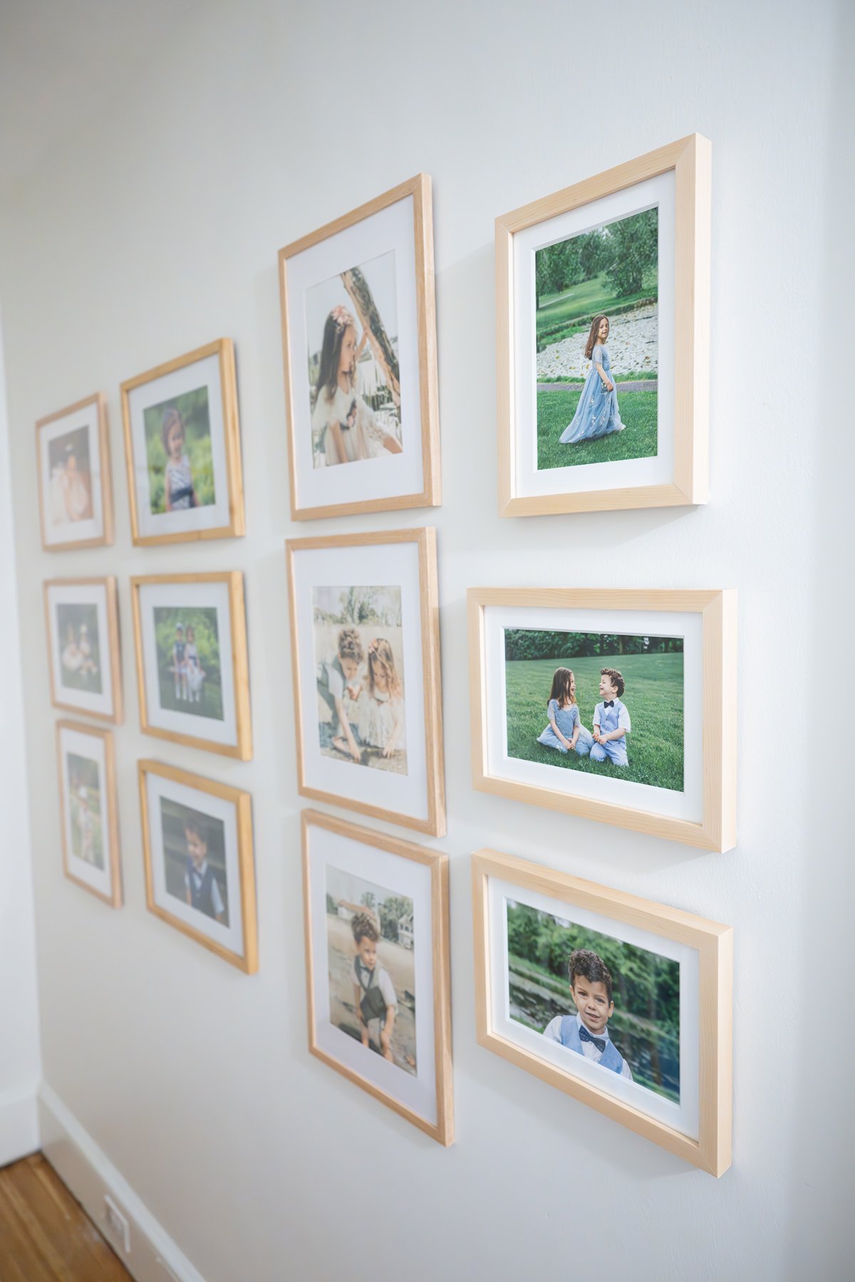 Maplewood NJ home wall decorated with multiple framed family photographs of children.