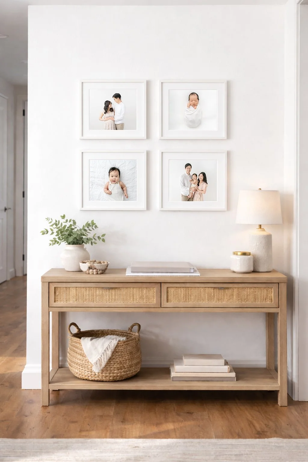 newborn baby and family portraits framed on white walls of south orange nj home